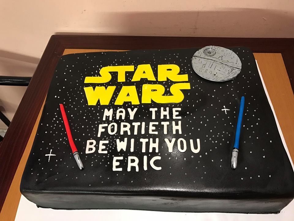 a star wars cake that says may the fortieth be with you eric