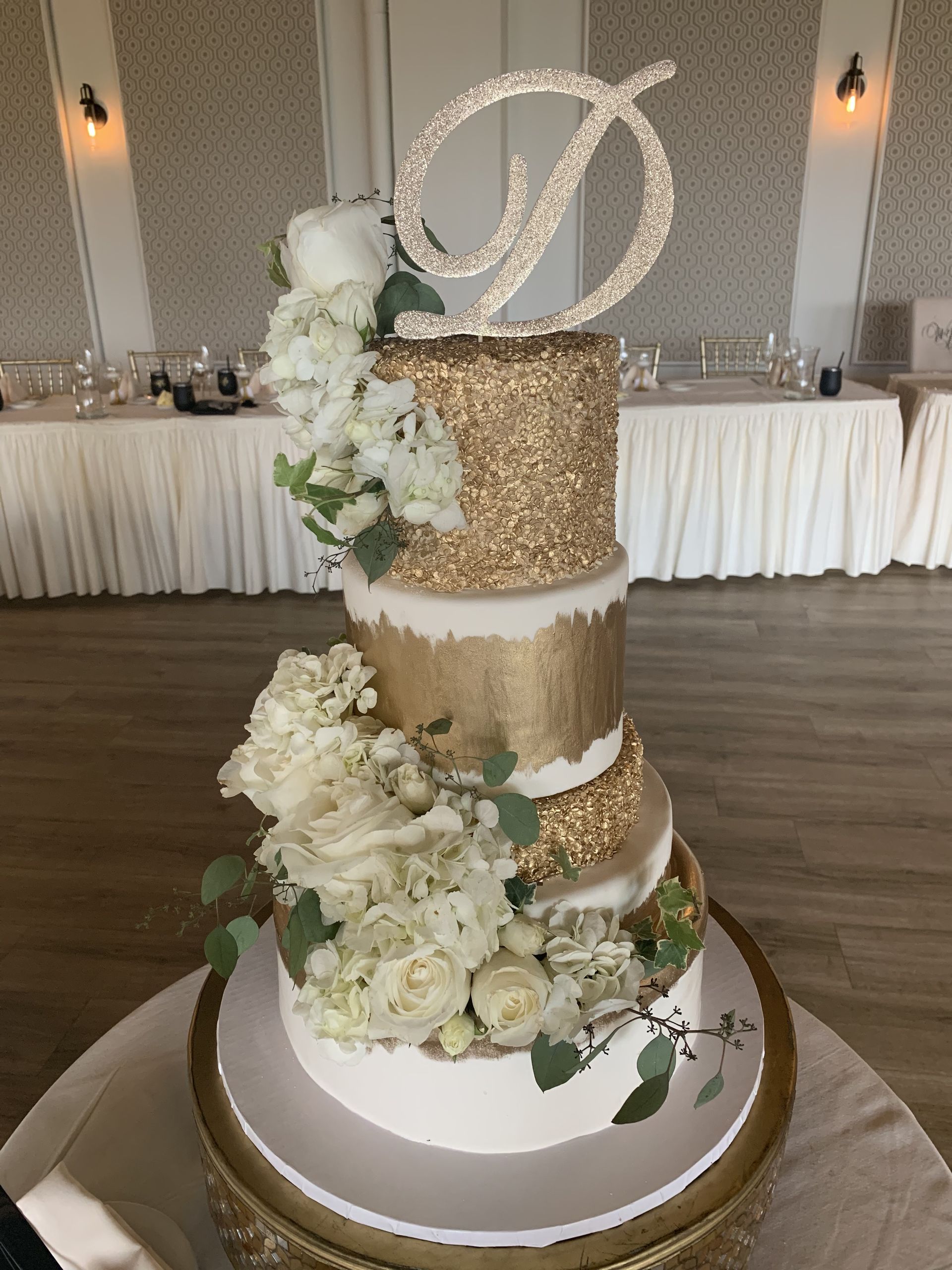 a wedding cake is sitting on top of a table .