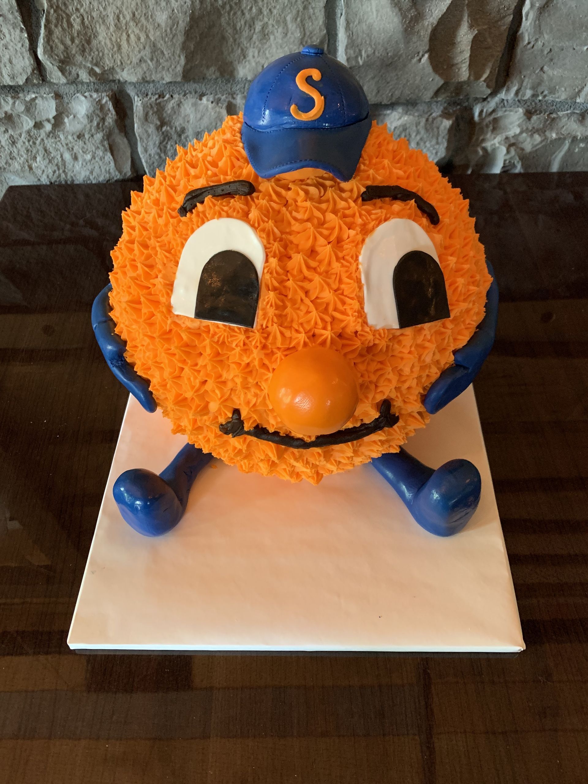 a cake that looks like a ball with a letter s on it