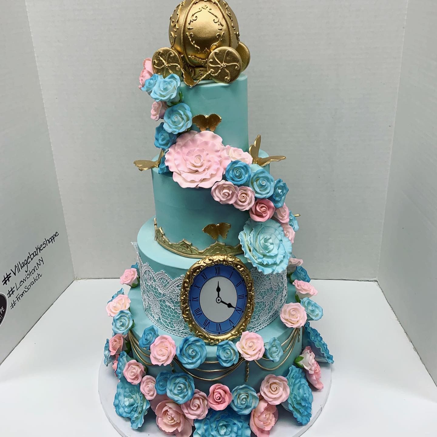 a cake with flowers and a clock on top of it