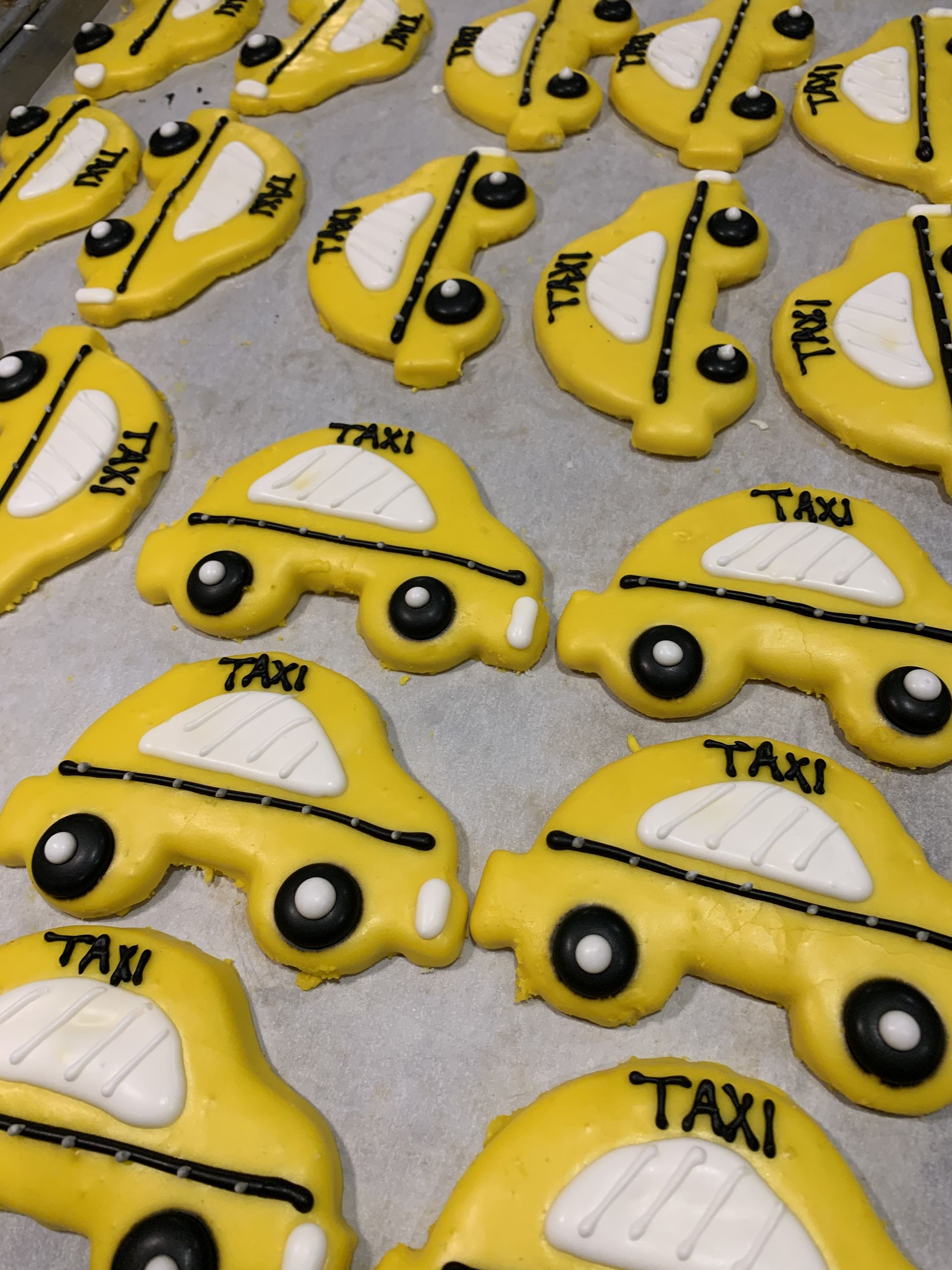 a bunch of cookies in the shape of a taxi