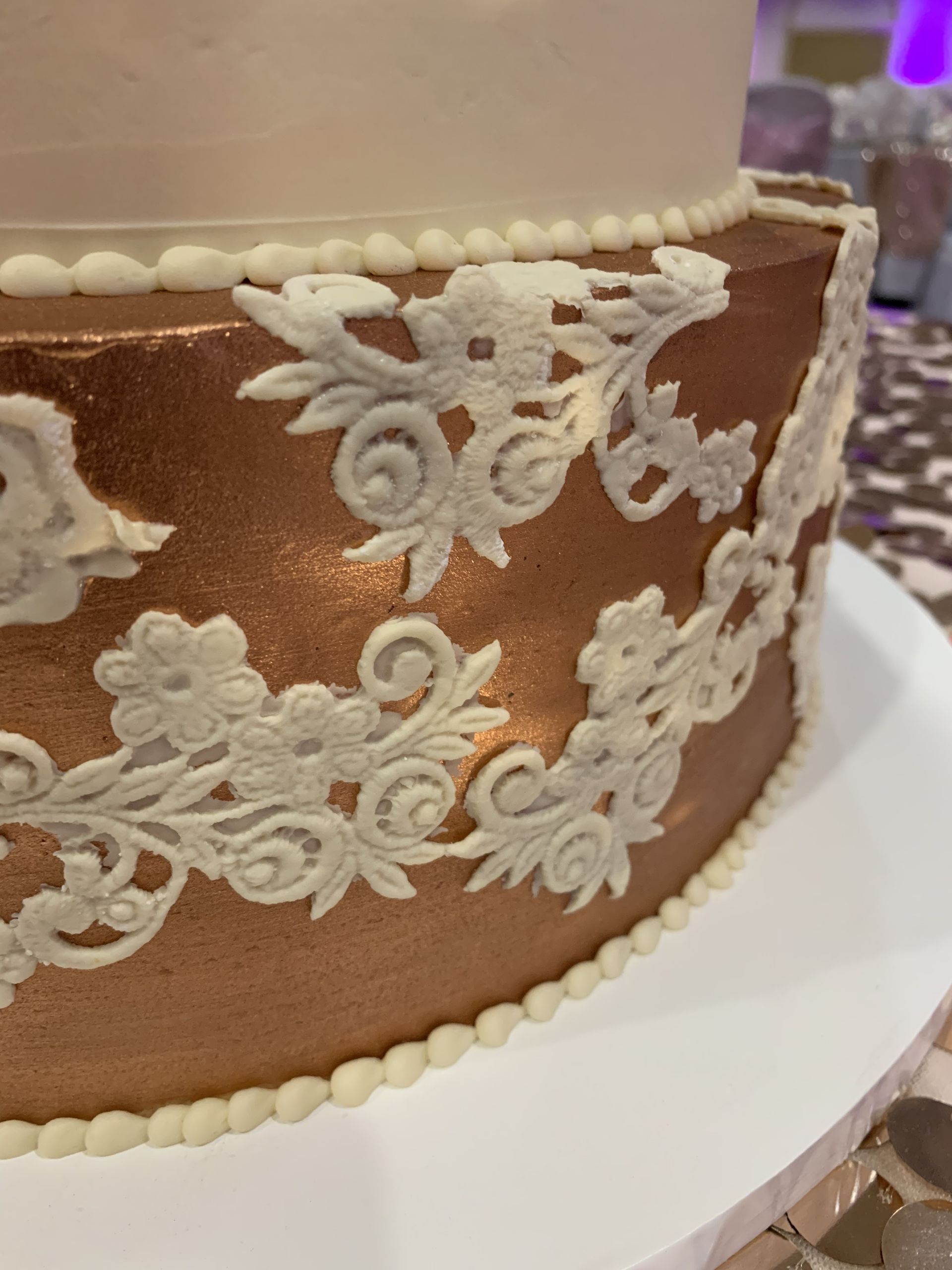 a close up of a cake with white frosting on a table .