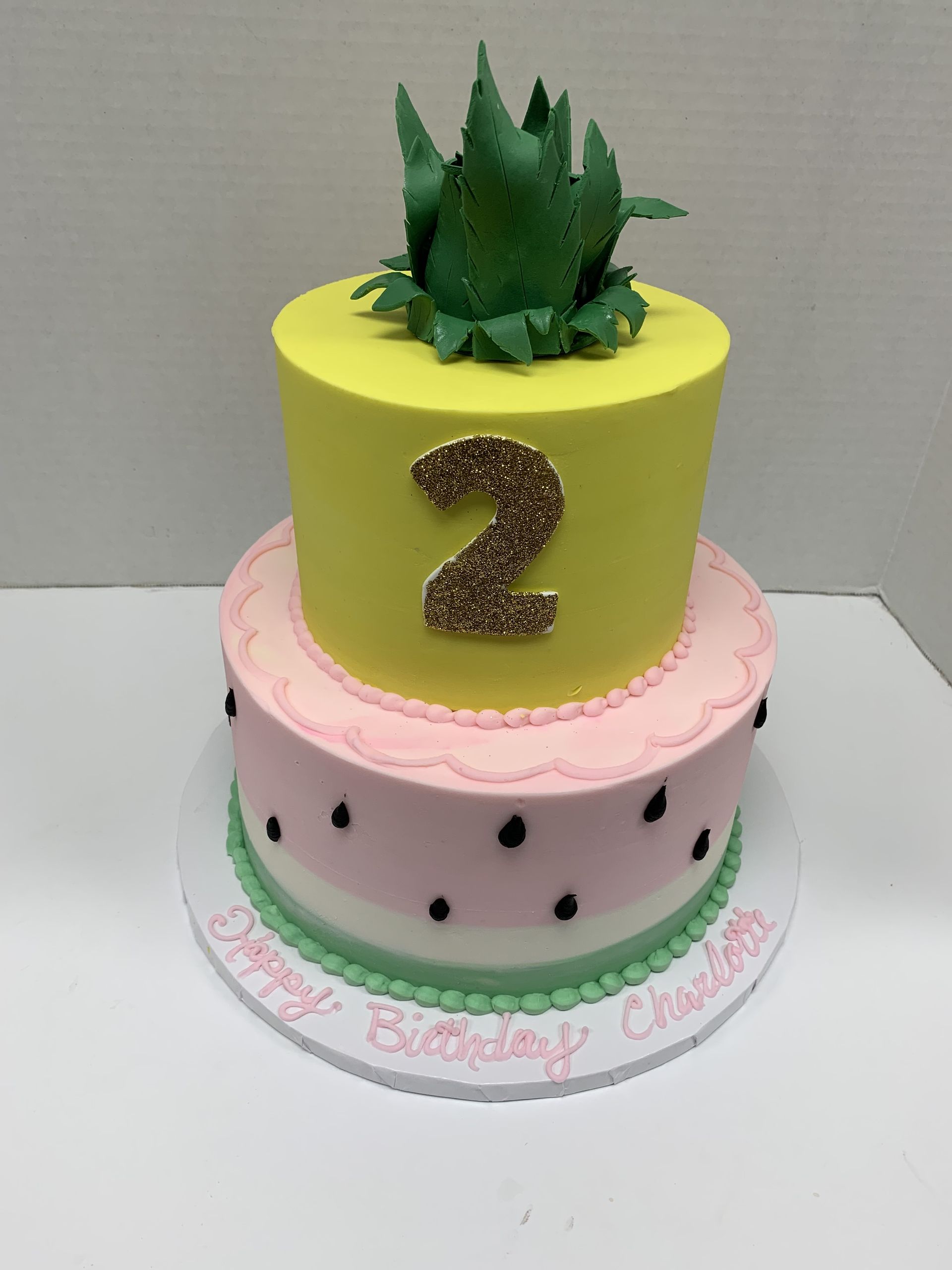 a birthday cake with a pineapple and the number 2 on it