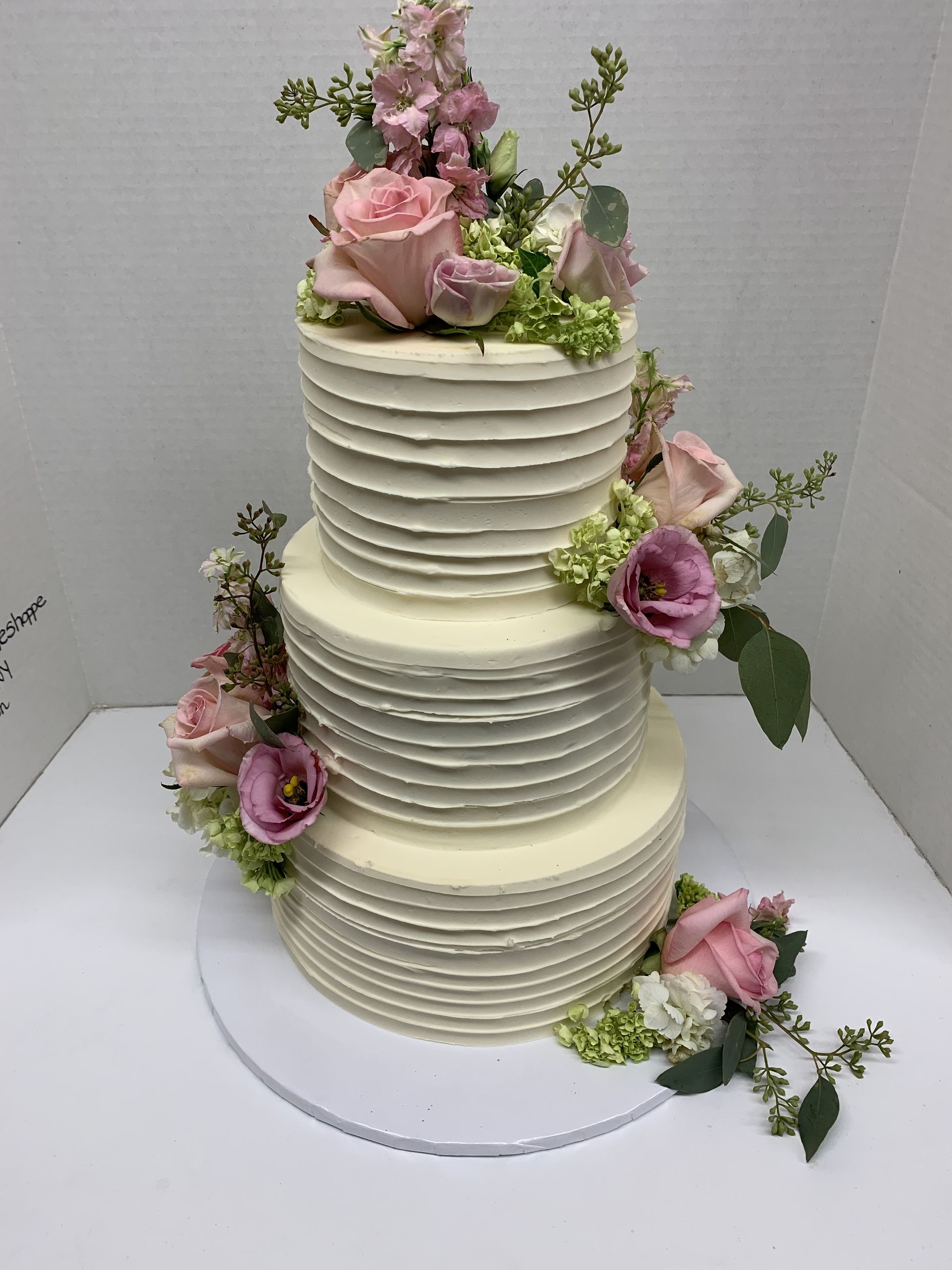a white cake with pink flowers on top of it