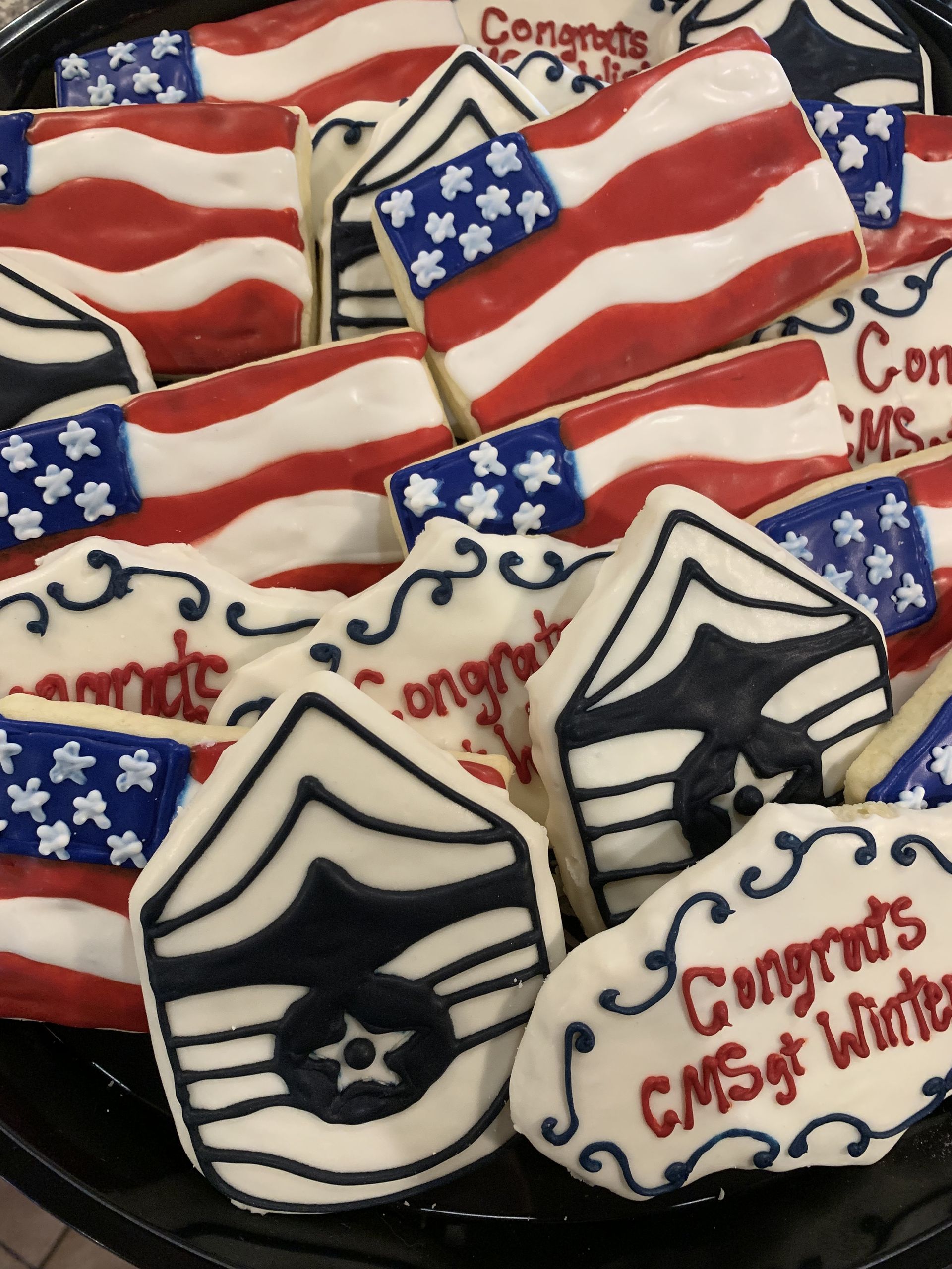 a bunch of cookies with american flags and congratulations written on them