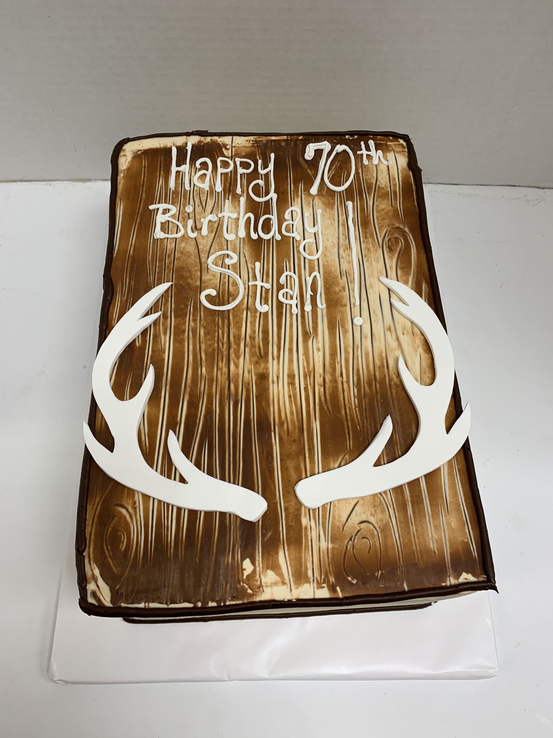 a 70th birthday cake with antlers on it
