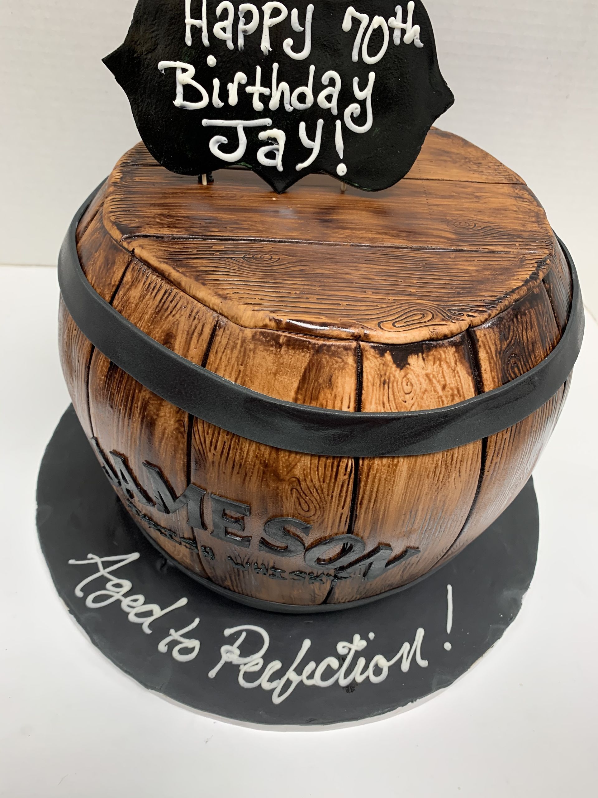 a birthday cake in the shape of a wooden barrel