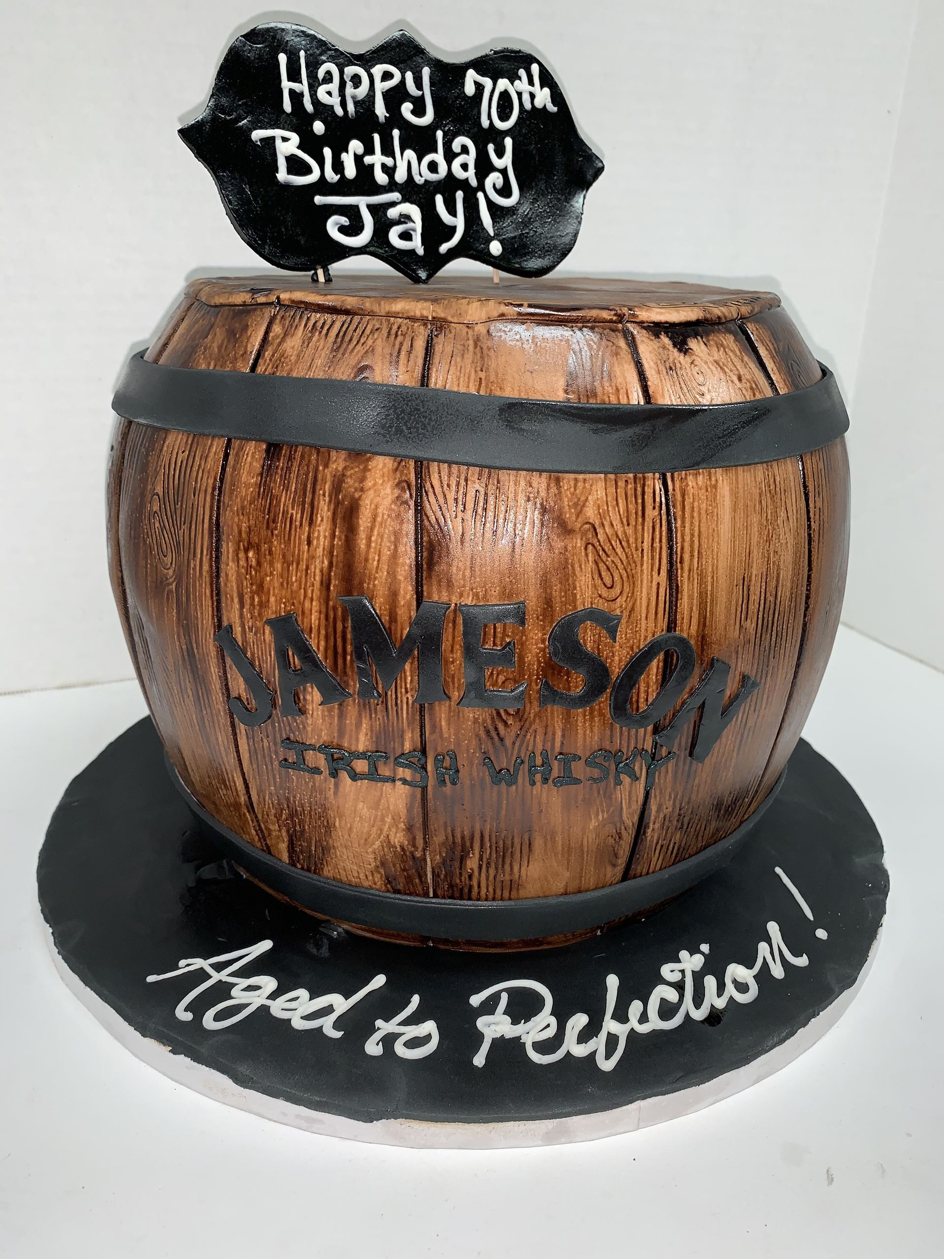 a cake that looks like a barrel of jameson whiskey