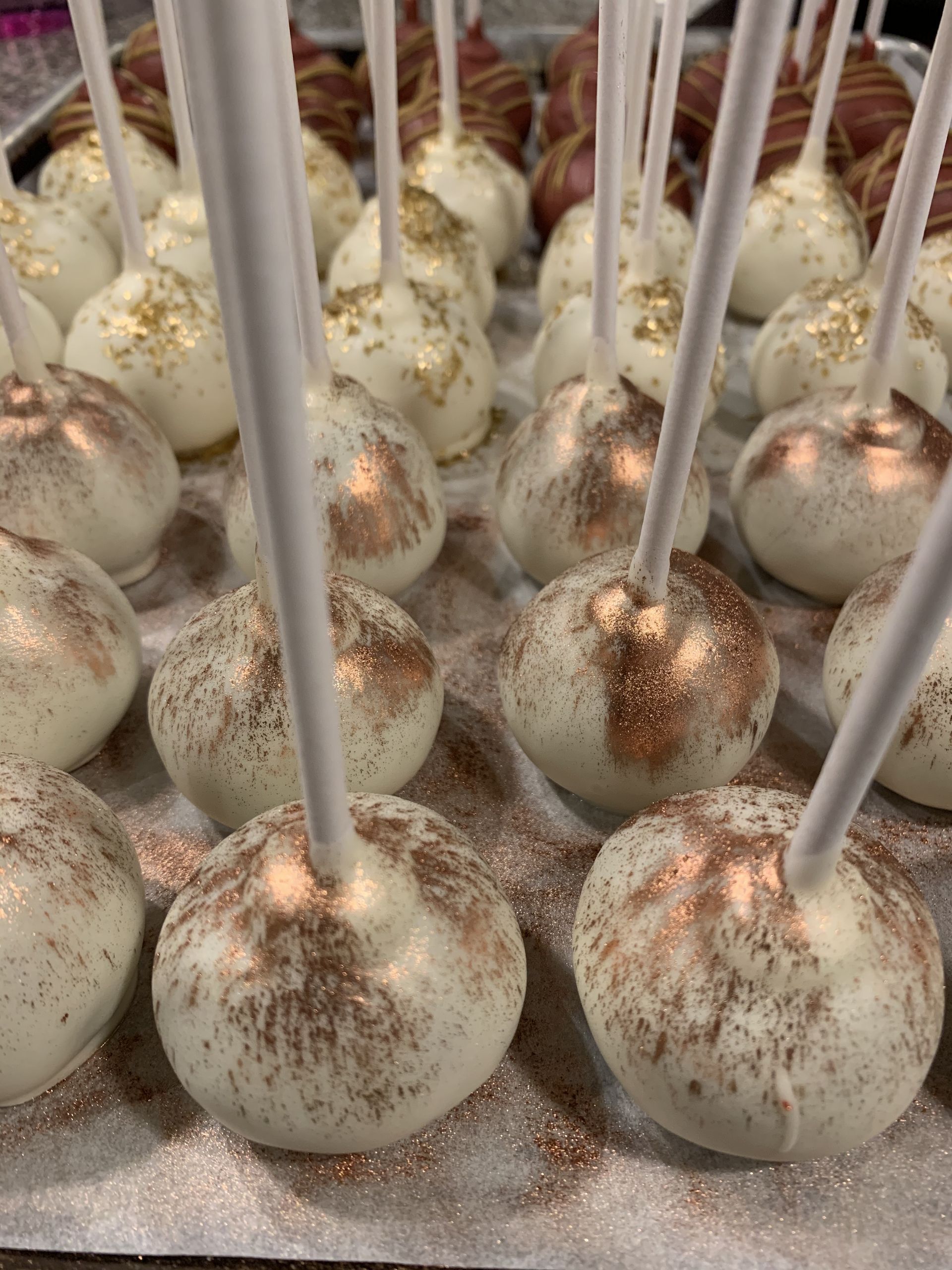 a bunch of cake pops sitting on top of a table .