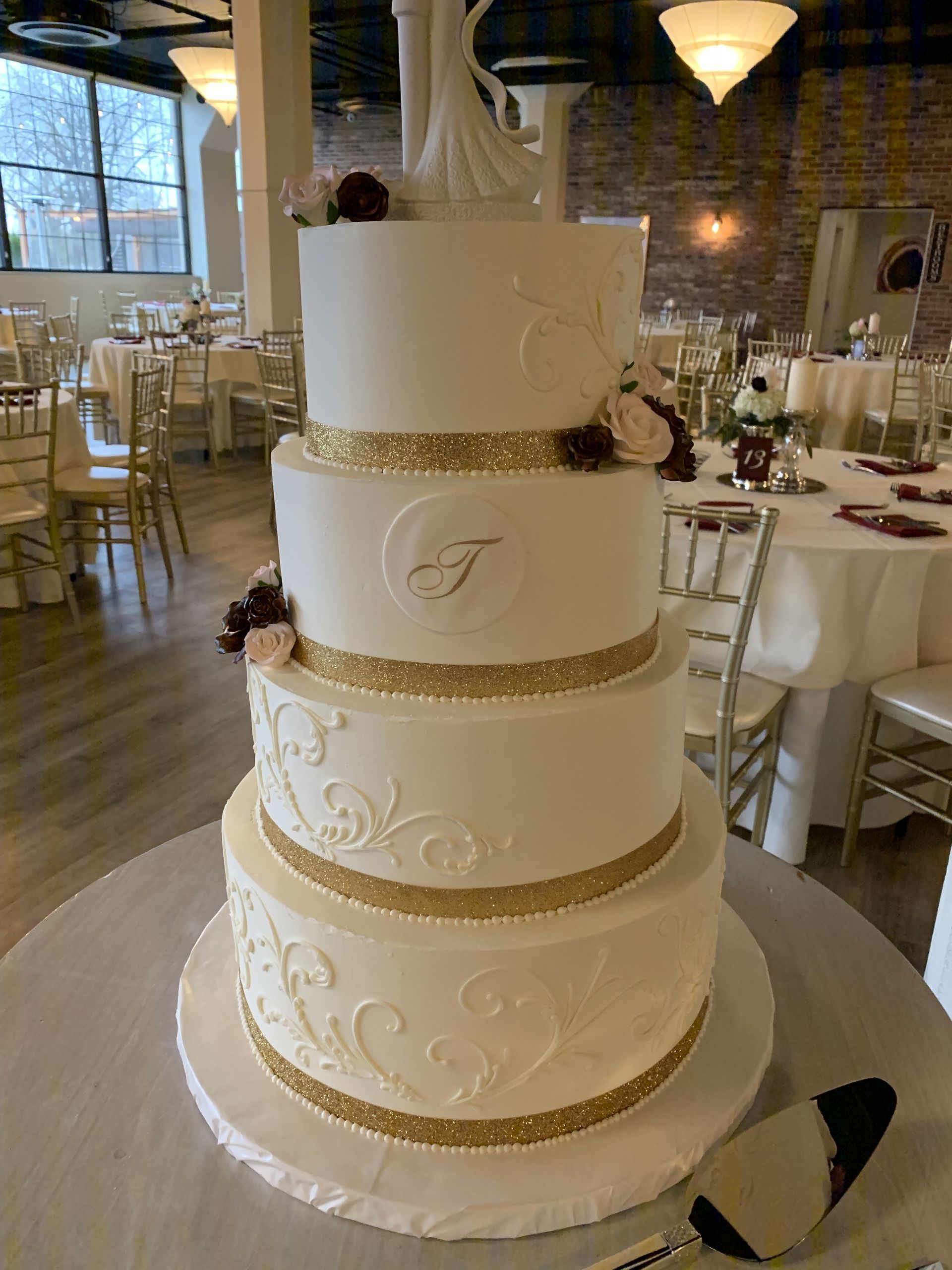 a wedding cake is sitting on a table in a room .