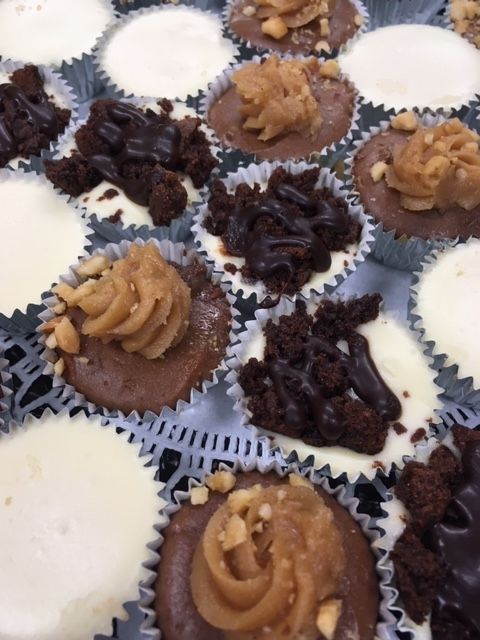 a bunch of cupcakes with different toppings on them