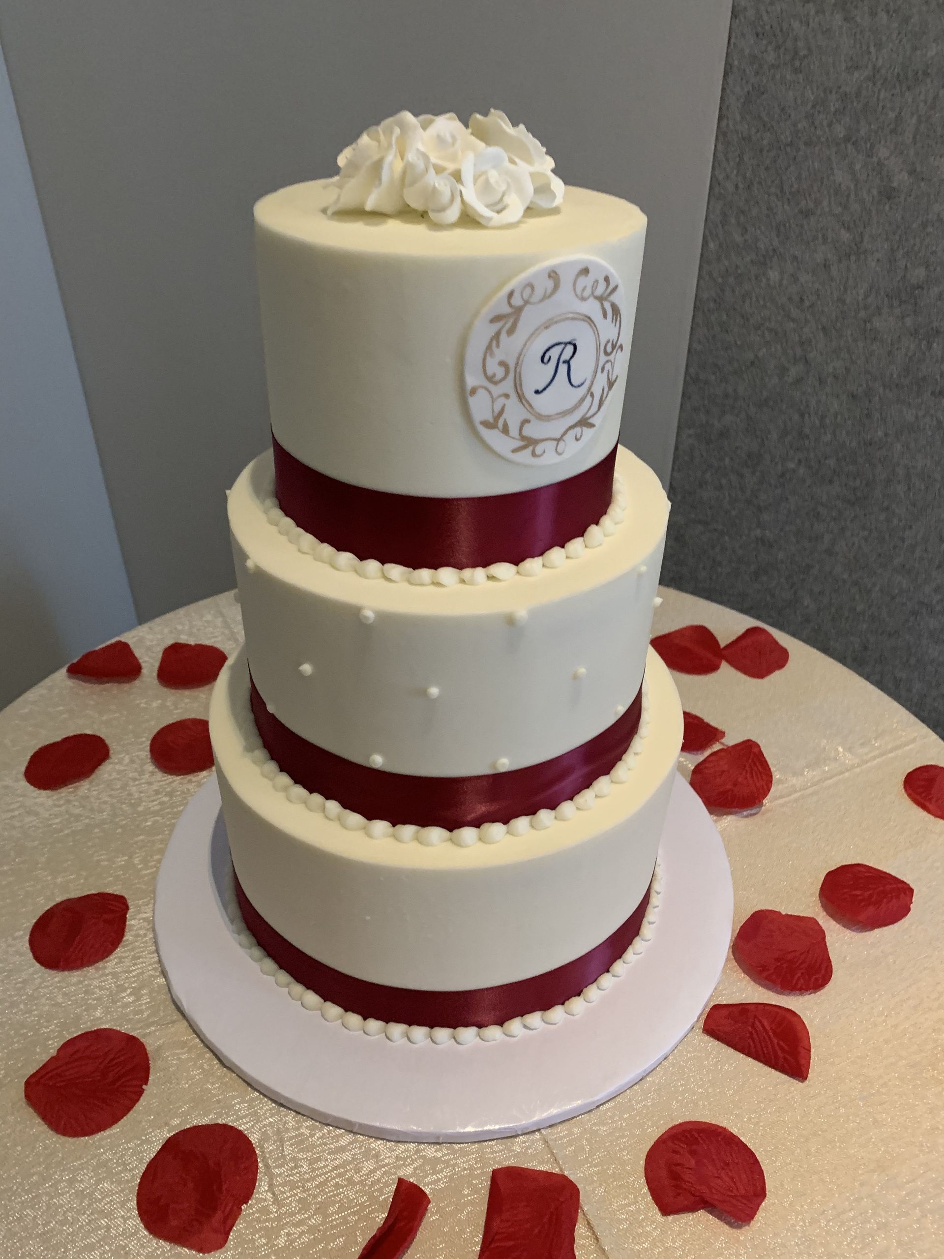a wedding cake with the letter r on it