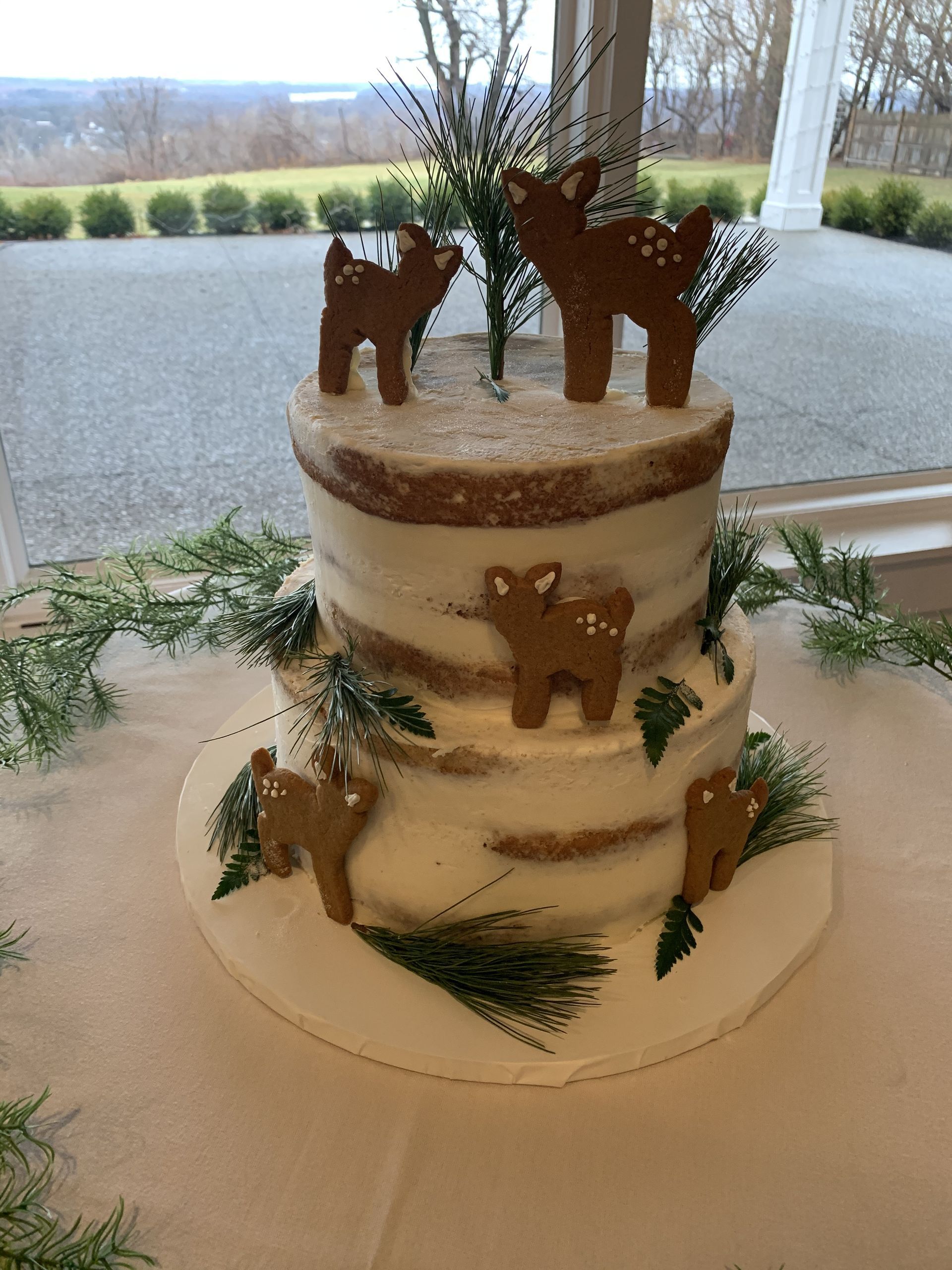 a cake with two deer on top of it is on a table .