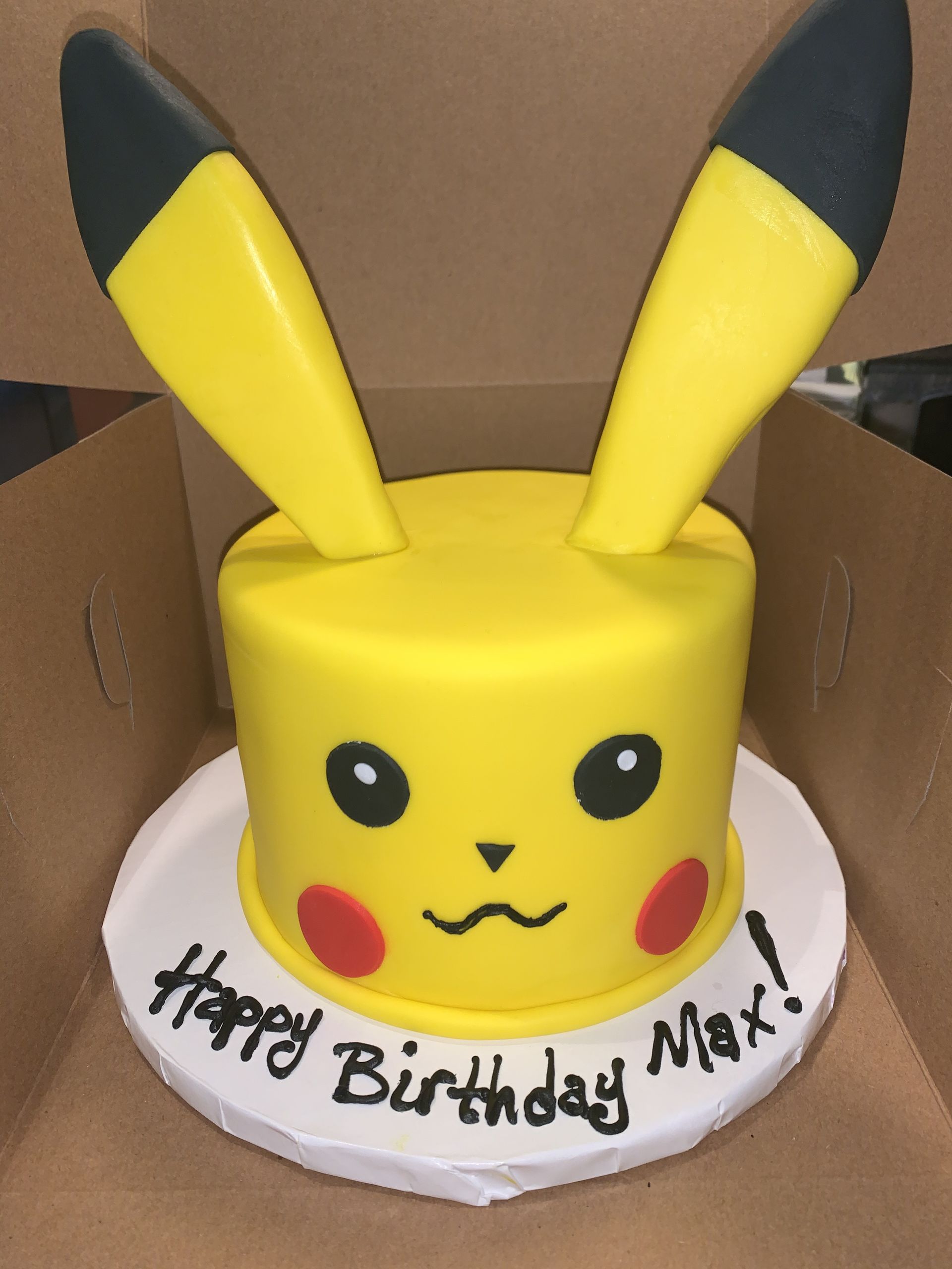 a pikachu cake with the words happy birthday max written on it