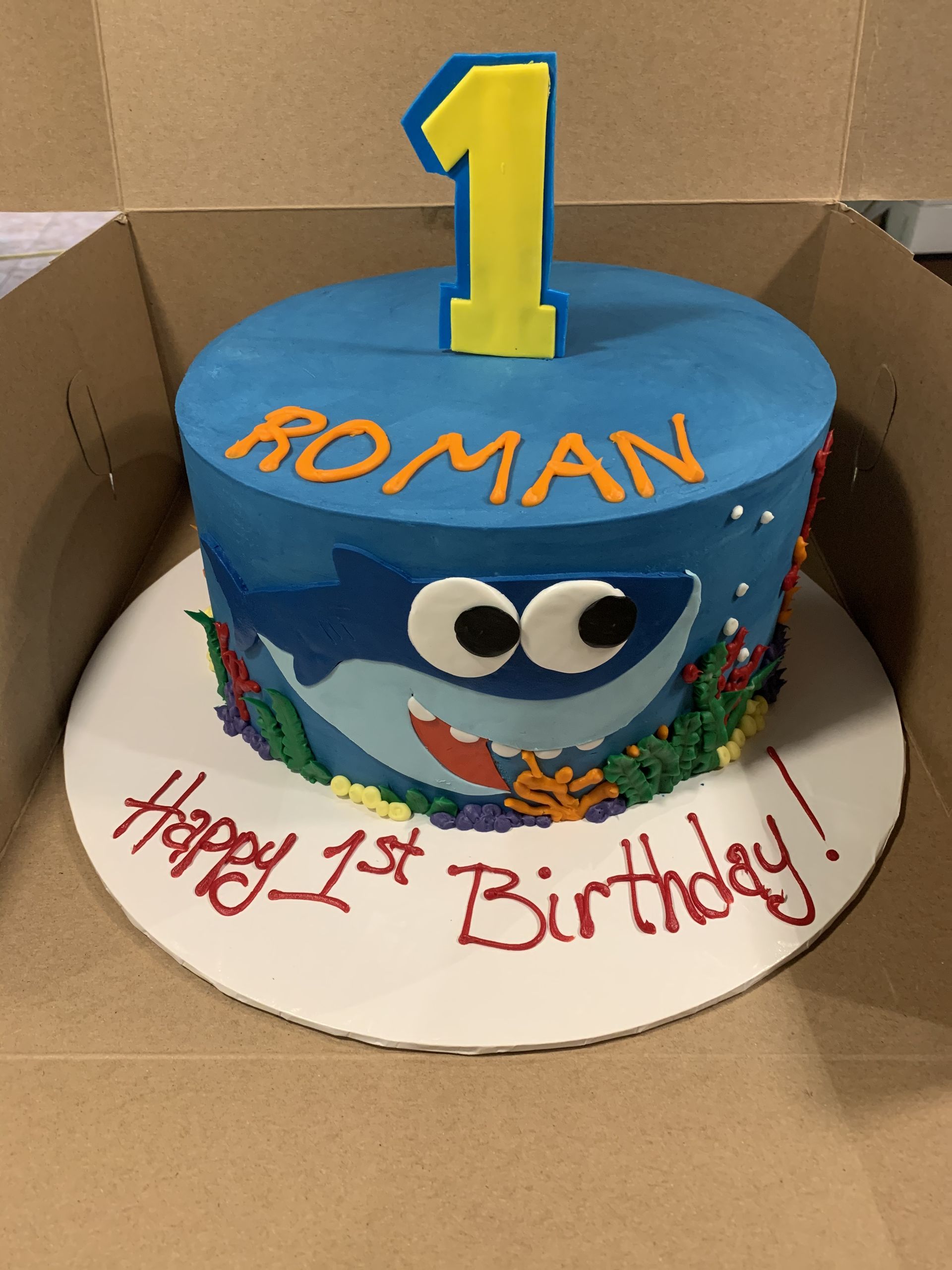 a birthday cake for roman with a shark on it