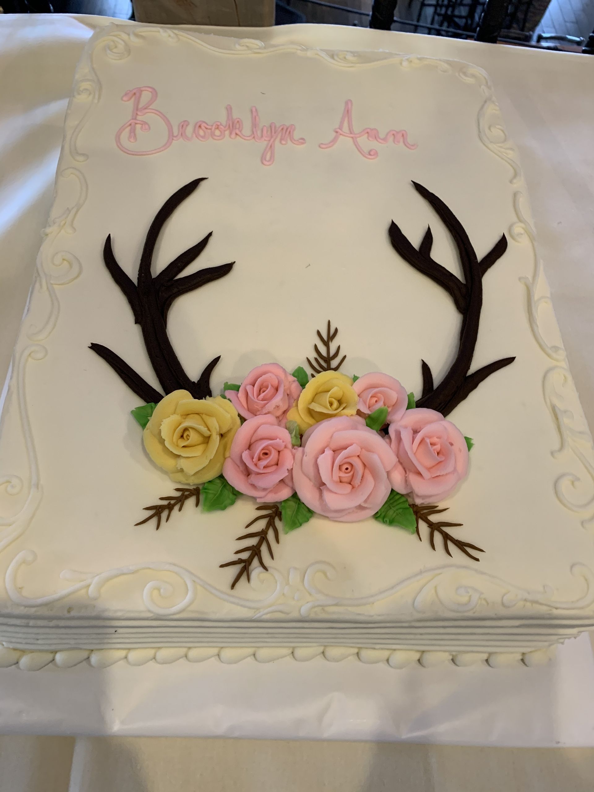 a cake with antlers and flowers on it is for brooklyn ann