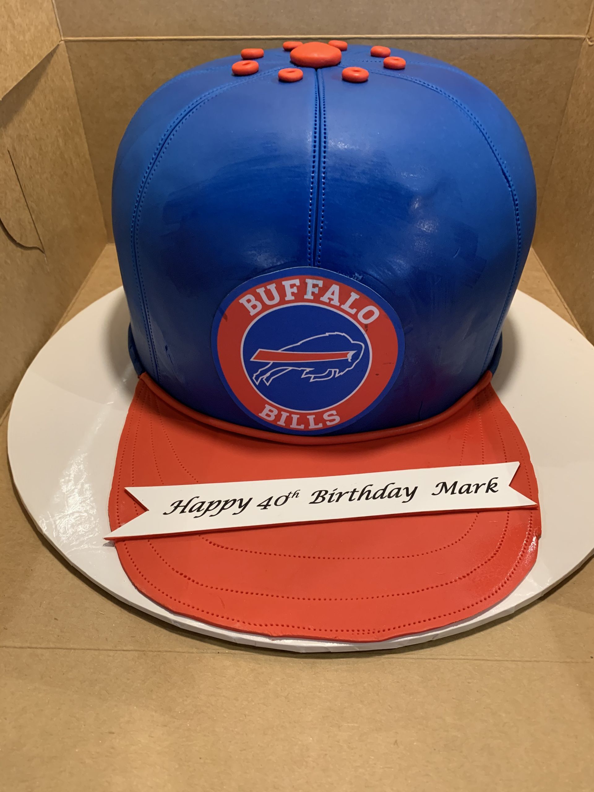 a cake in the shape of a buffalo bills hat