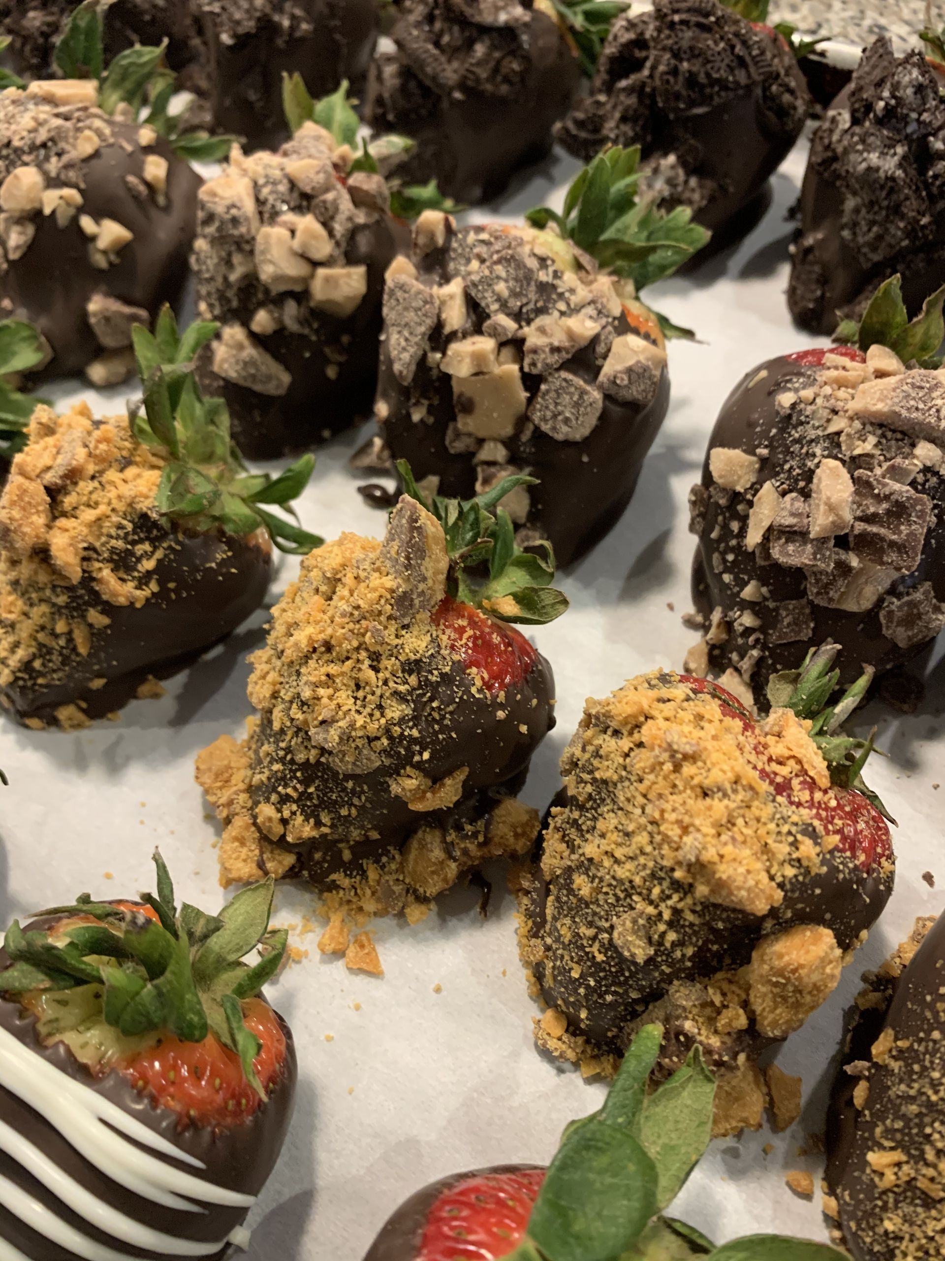 a bunch of chocolate covered strawberries on a table