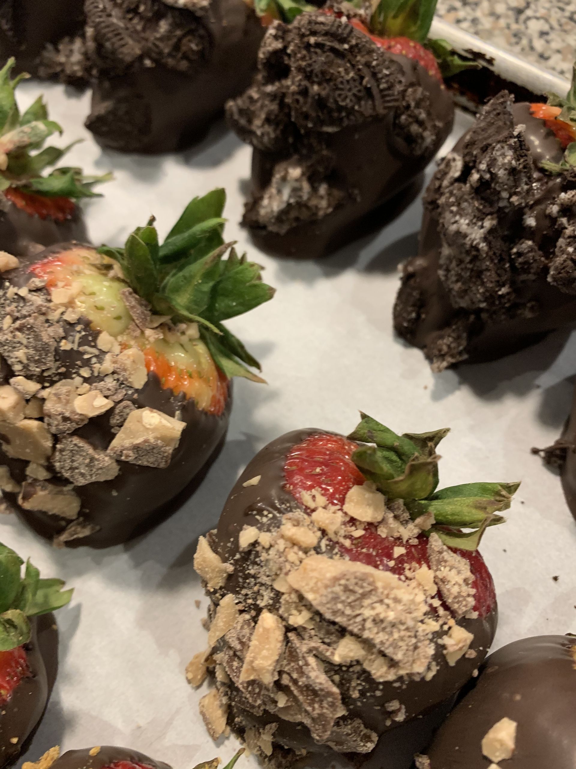 a bunch of chocolate covered strawberries on a table