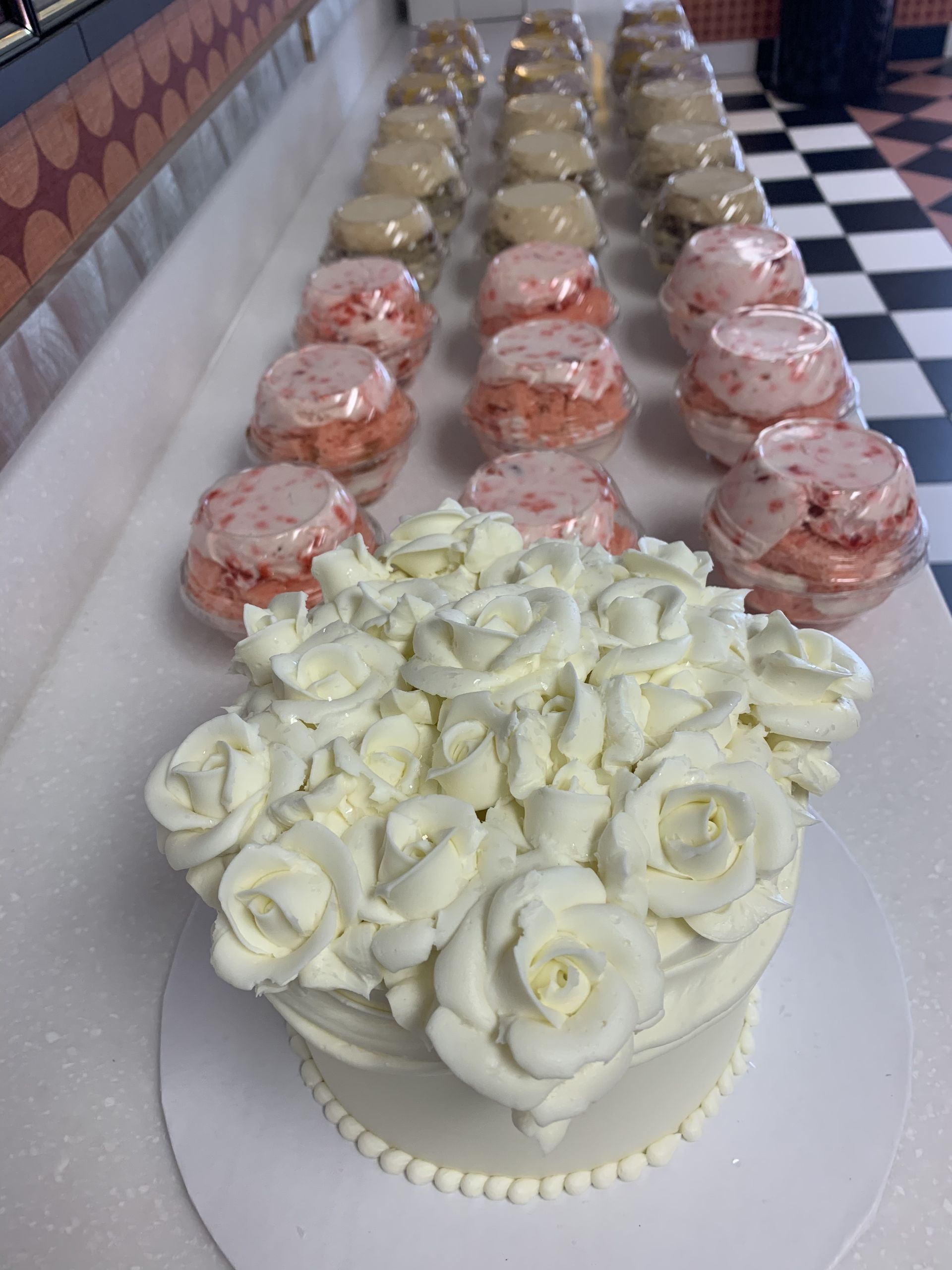 a cake with white frosting and roses on top of it