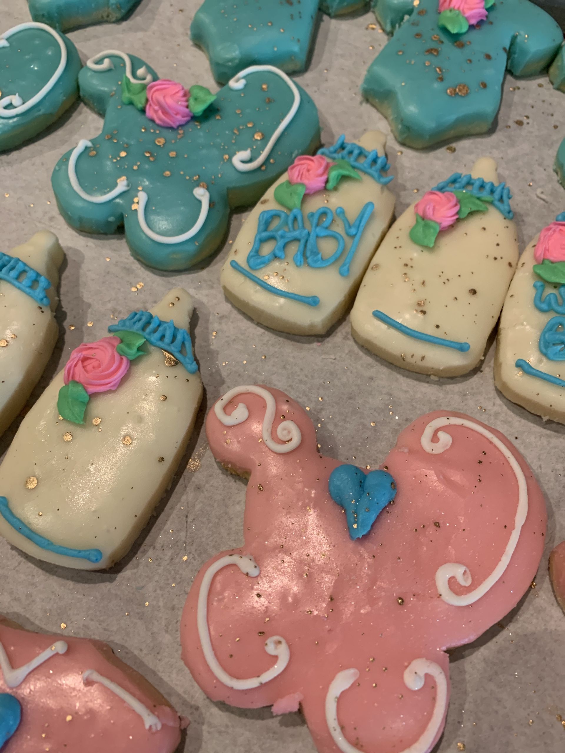 a bunch of cookies with one that says ' sweet baby ' on it