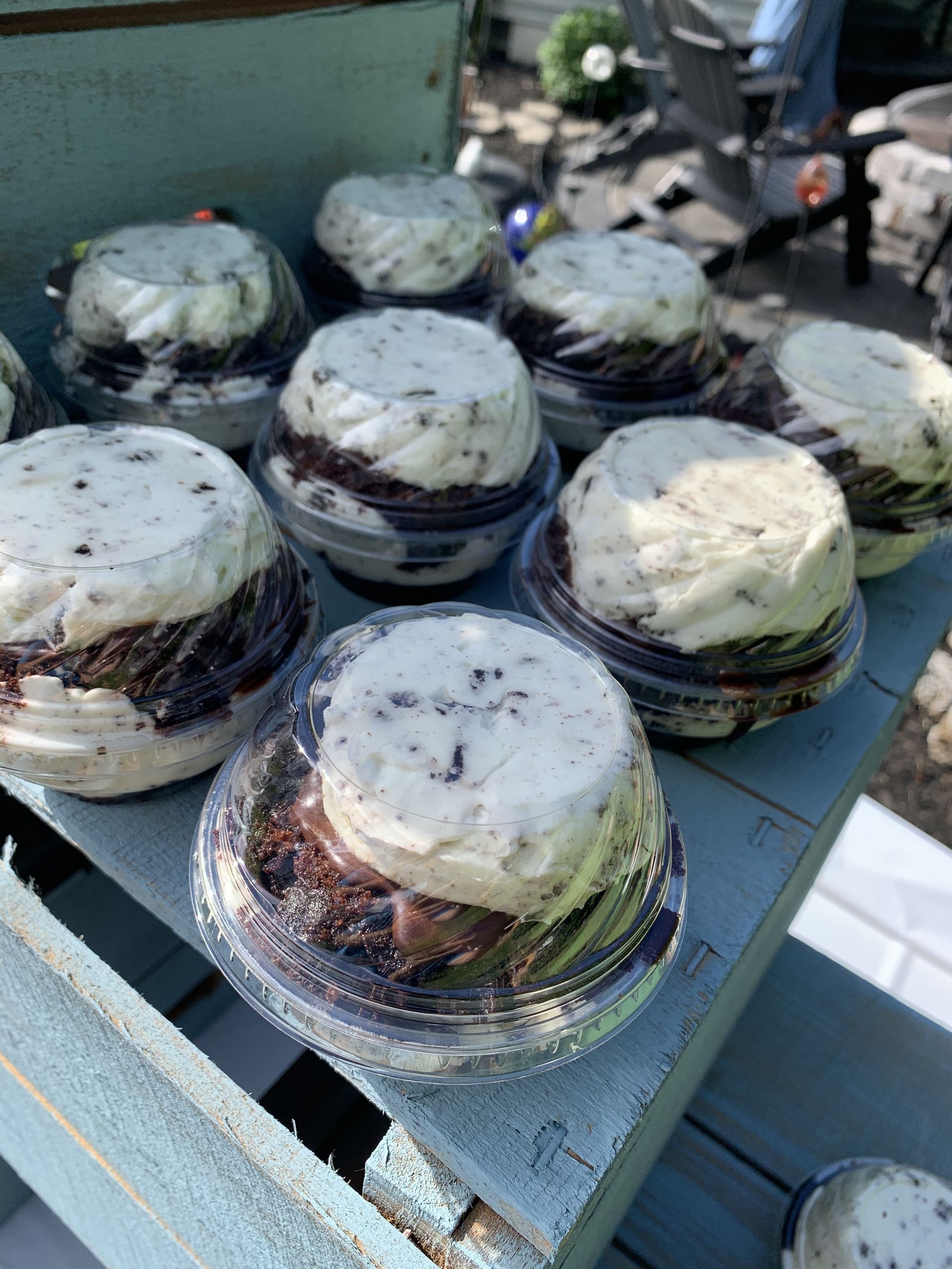 a bunch of cupcakes are sitting on top of a wooden table .