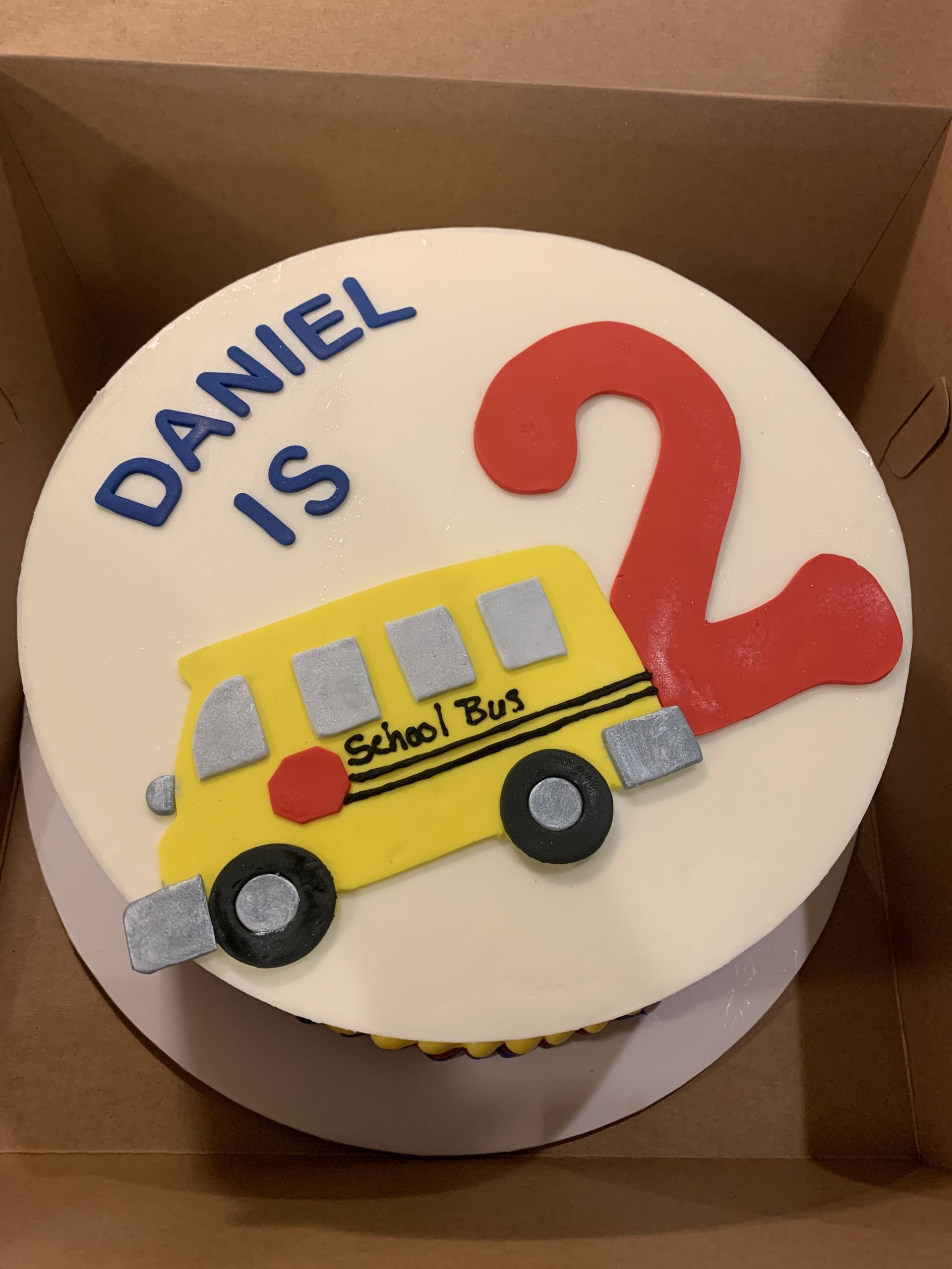 a birthday cake for daniel with a school bus on it
