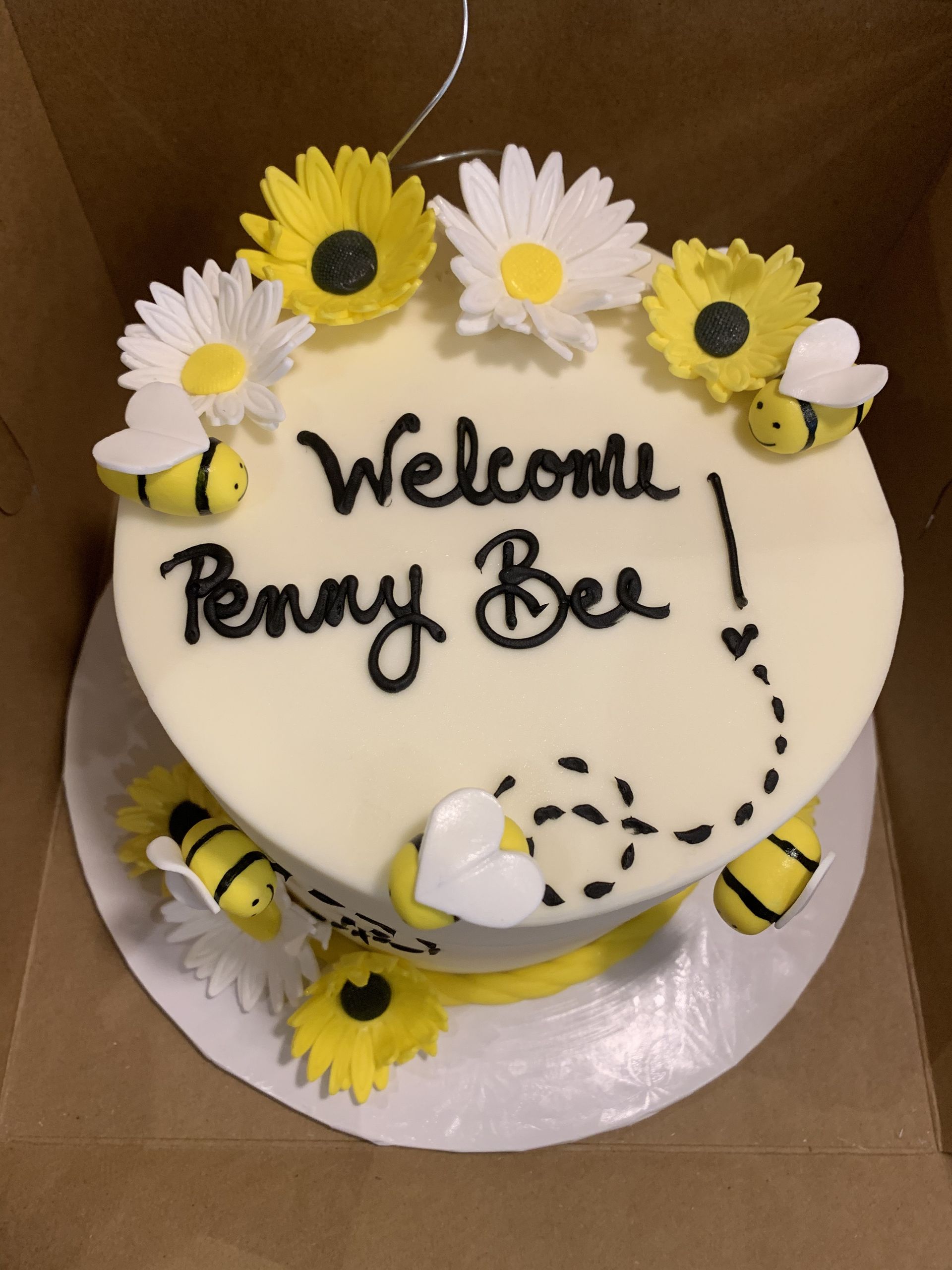 a cake that says welcome penny bee on it