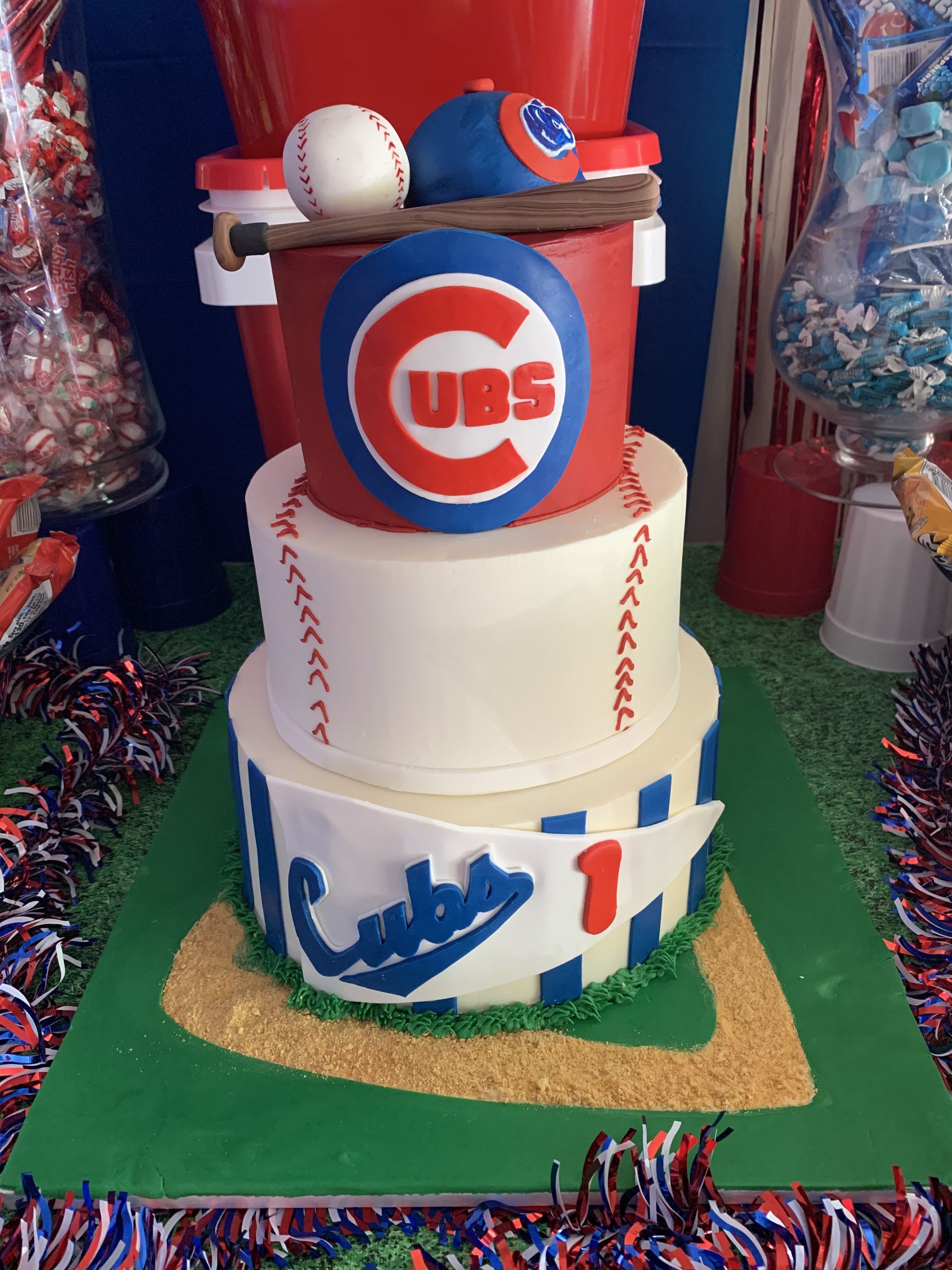a three tiered cake with a cubs logo on it
