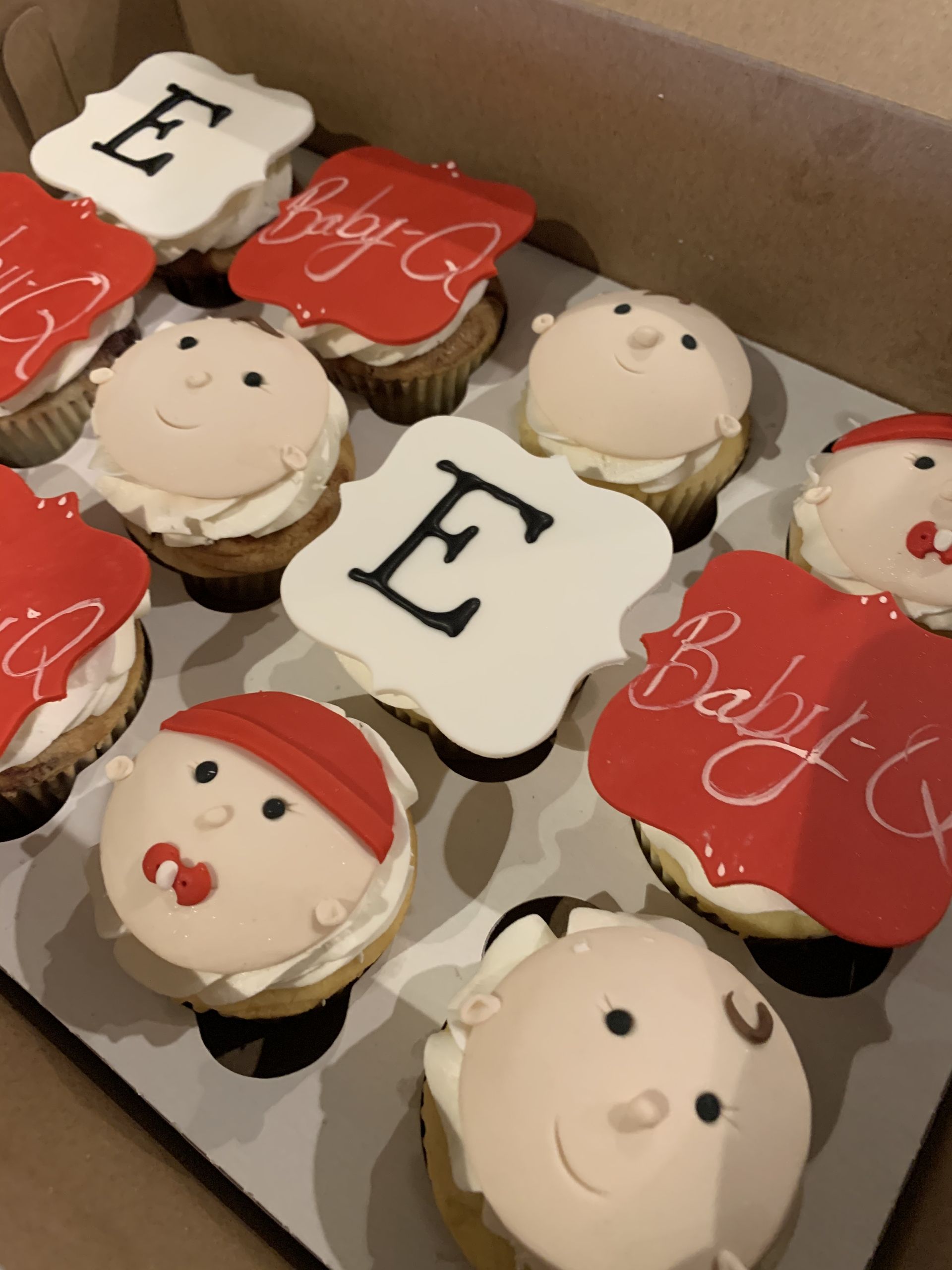 a box of cupcakes with the letter e on them