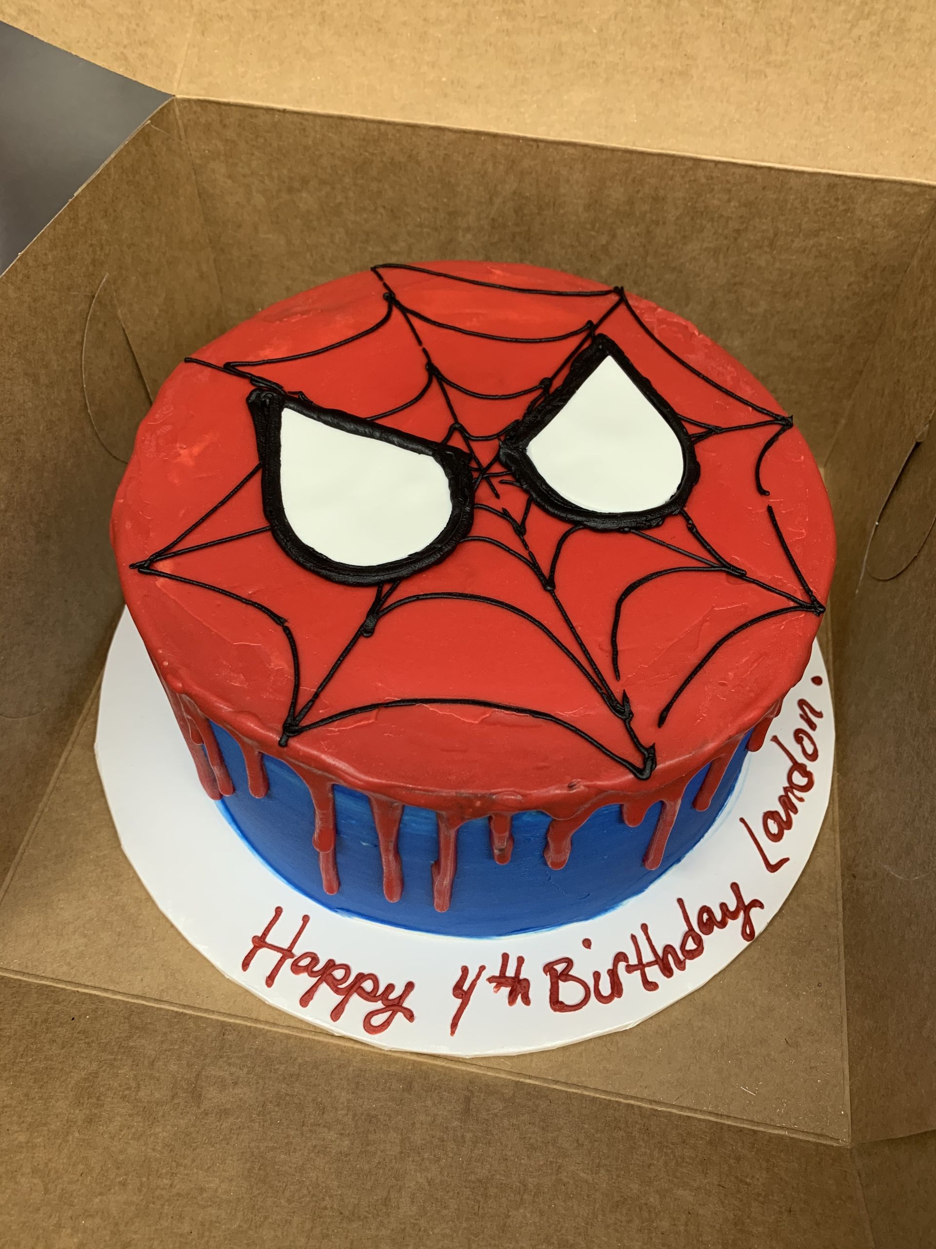 a birthday cake with a spider man face on it