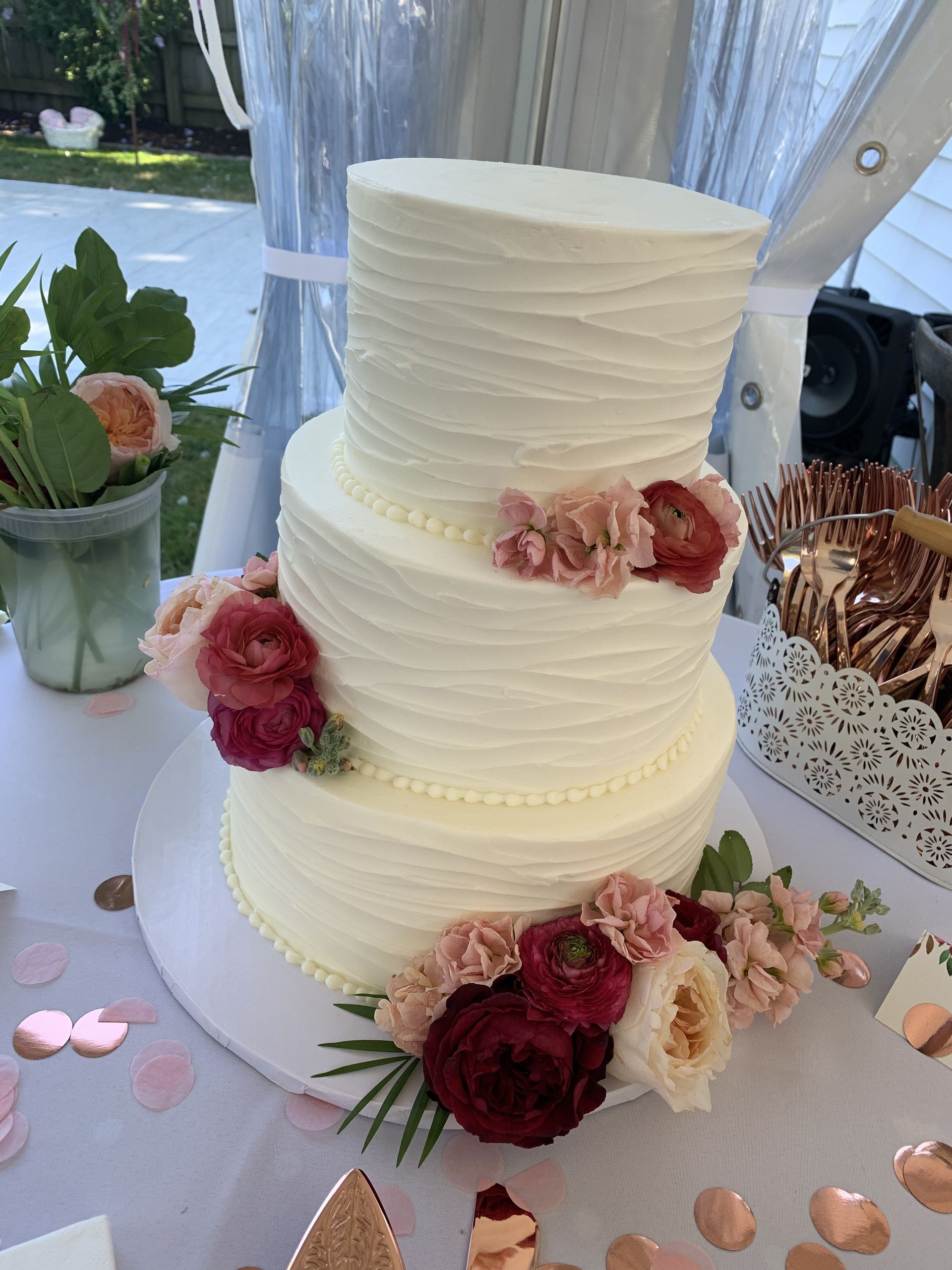 a wedding cake with flowers on top of it is on a table .