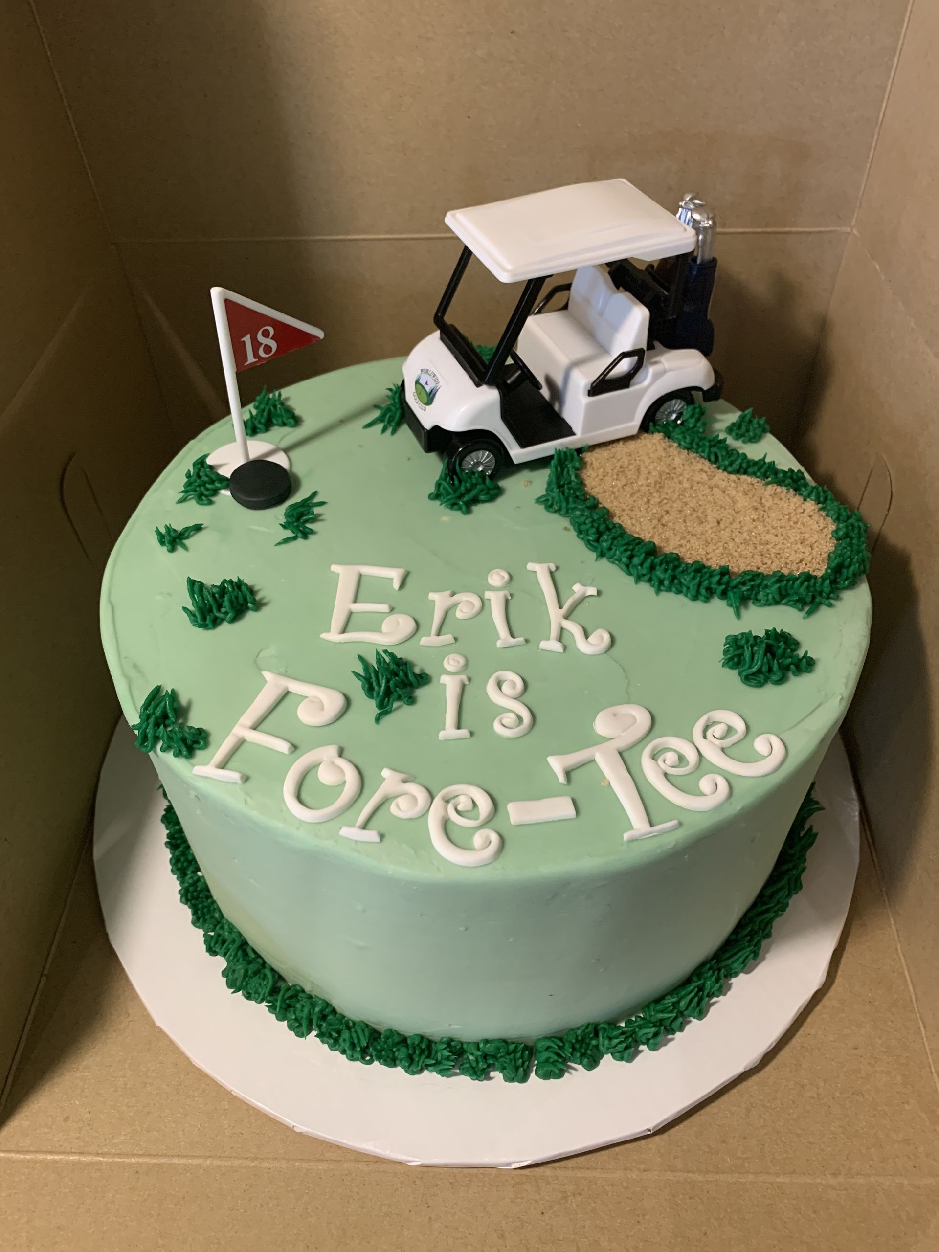 a cake with a golf cart on top that says erik is fore-tee