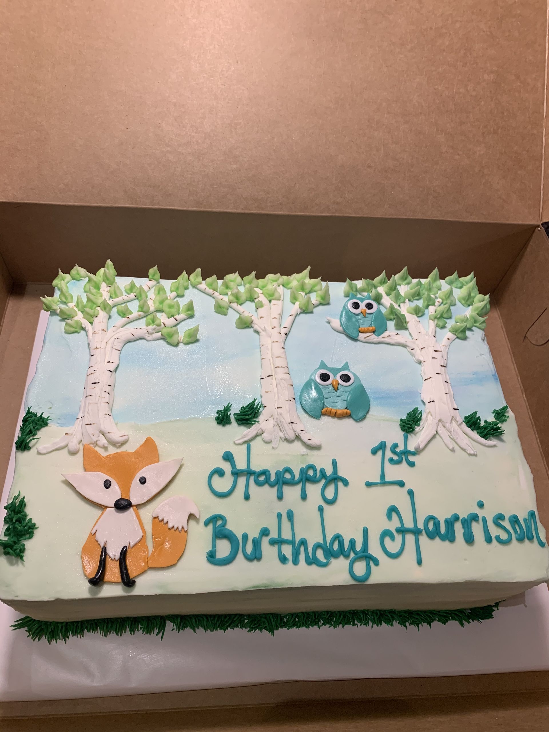 a birthday cake with a fox and owls on it