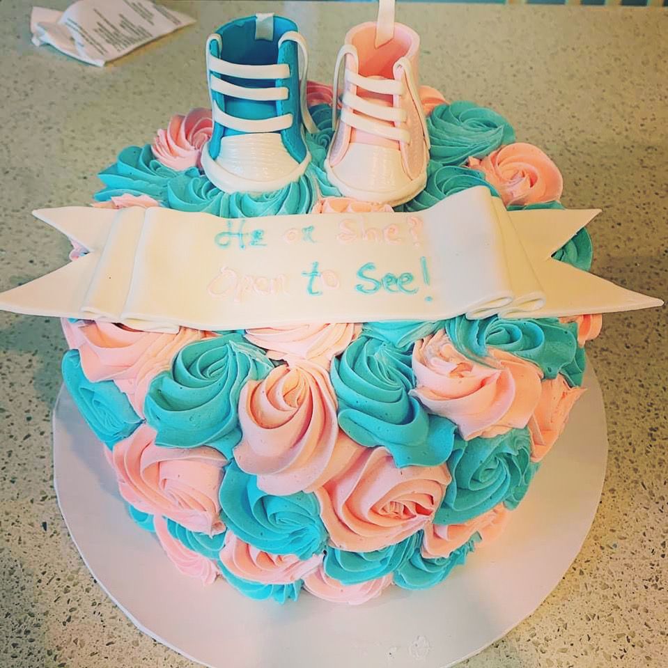 a baby shower cake with pink and blue frosting