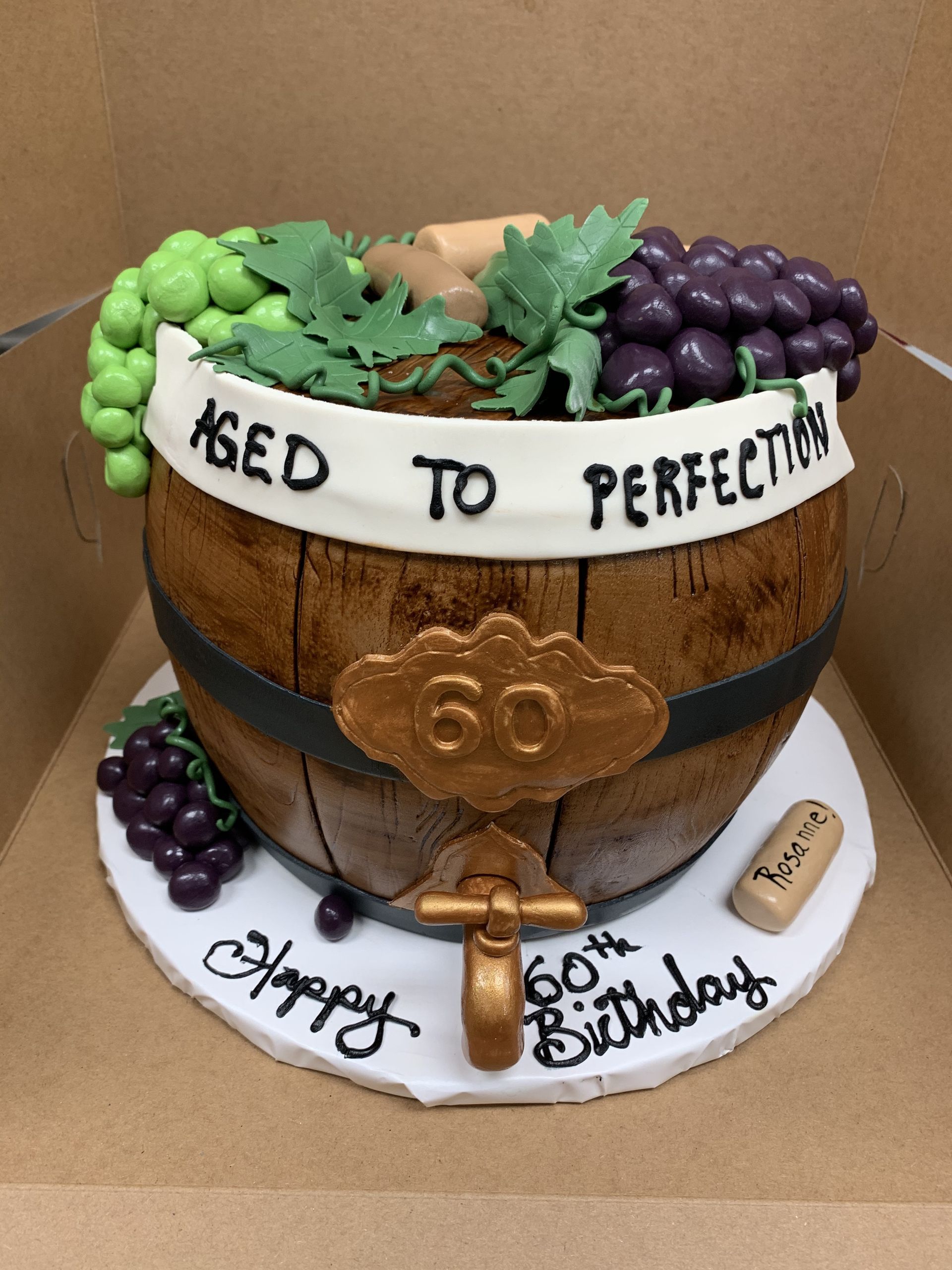 a 60th birthday cake in the shape of a wine barrel