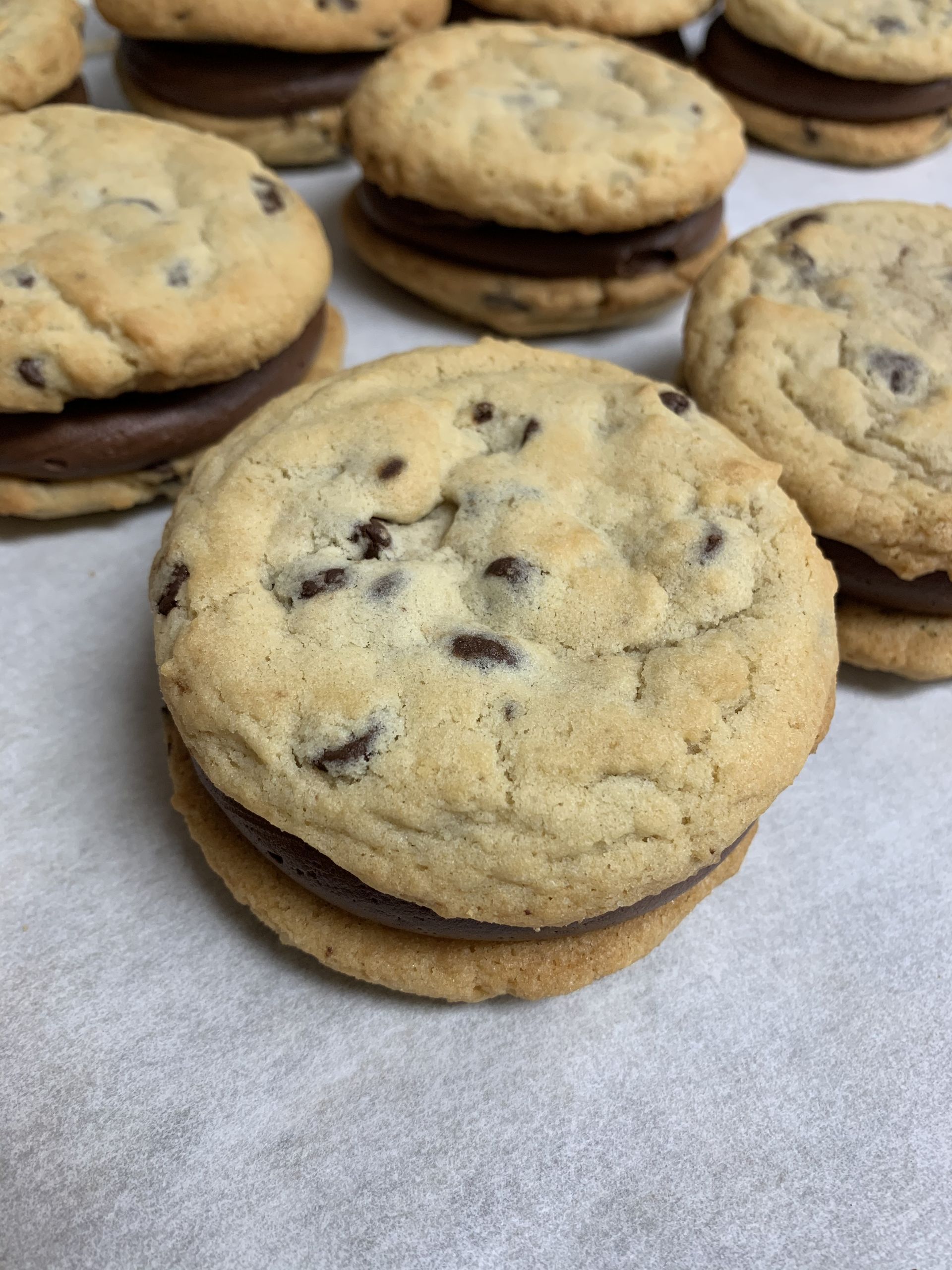 a close up of a chocolate chip cookie sandwich on a table