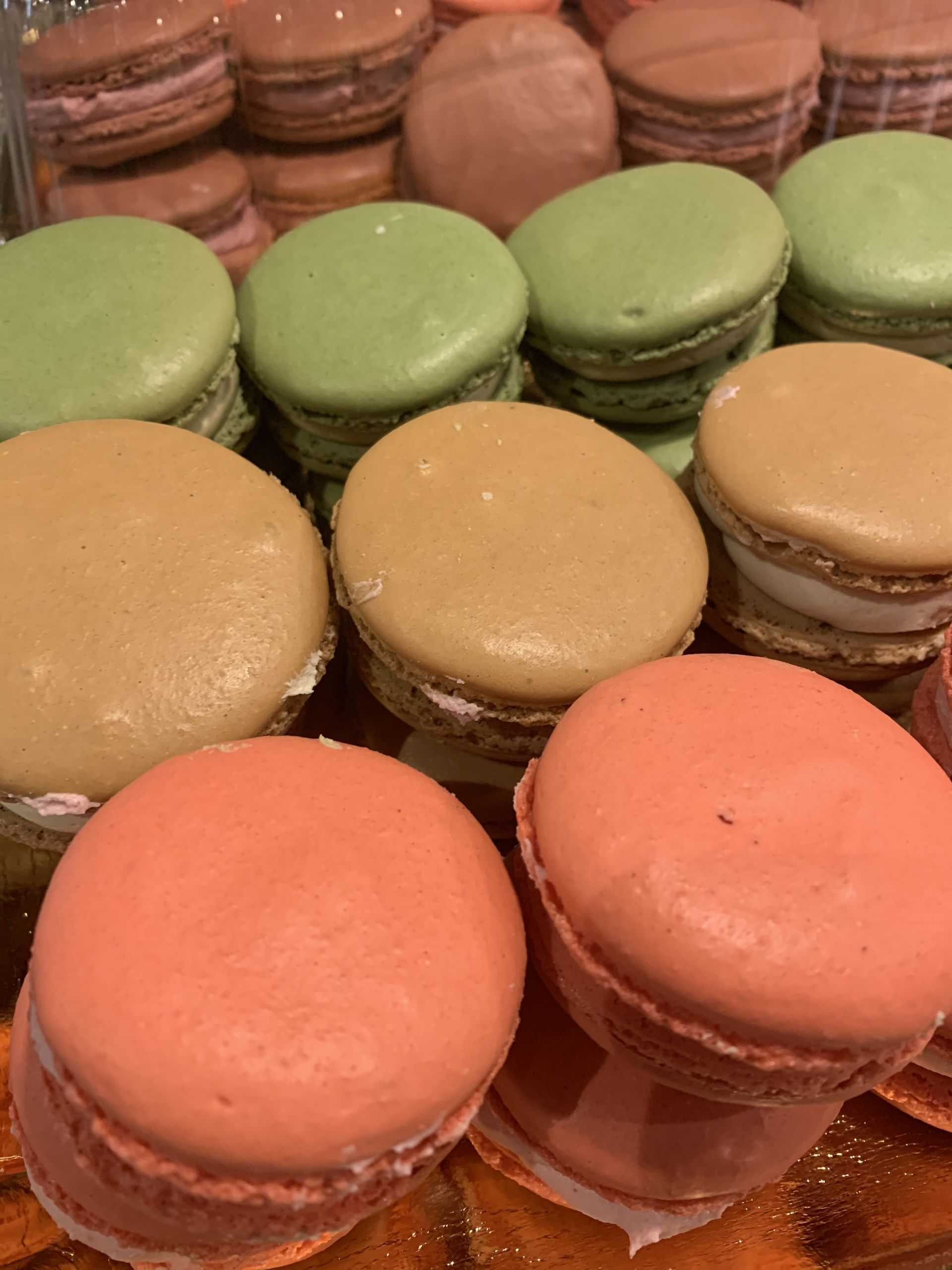 a bunch of different colored macarons are stacked on top of each other