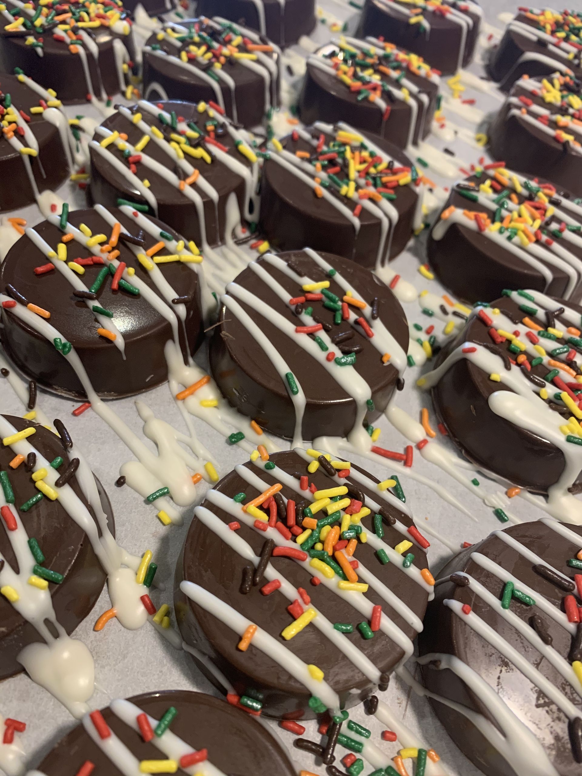 a bunch of chocolate cookies with sprinkles on them