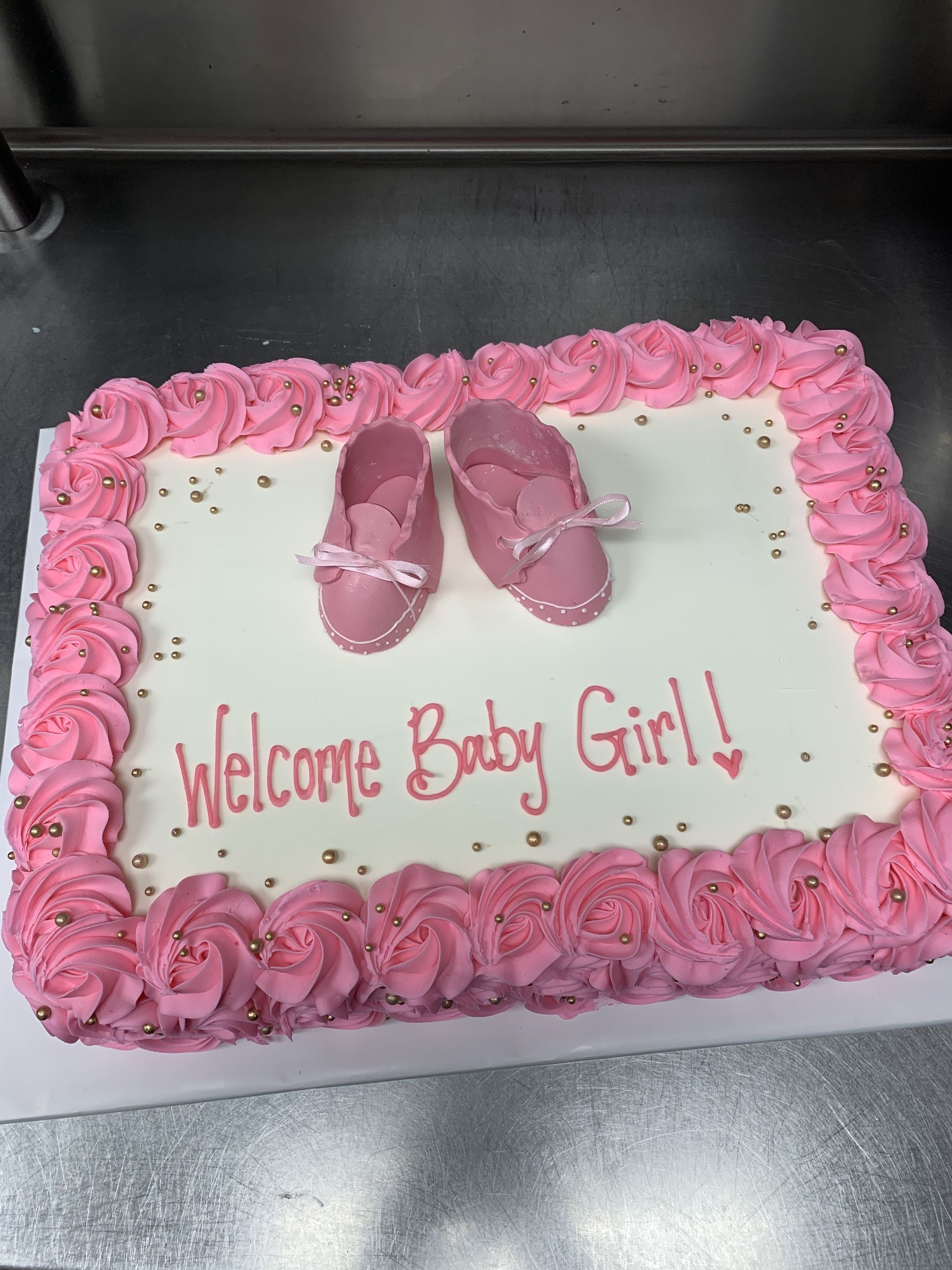 a cake that says welcome baby girl on it