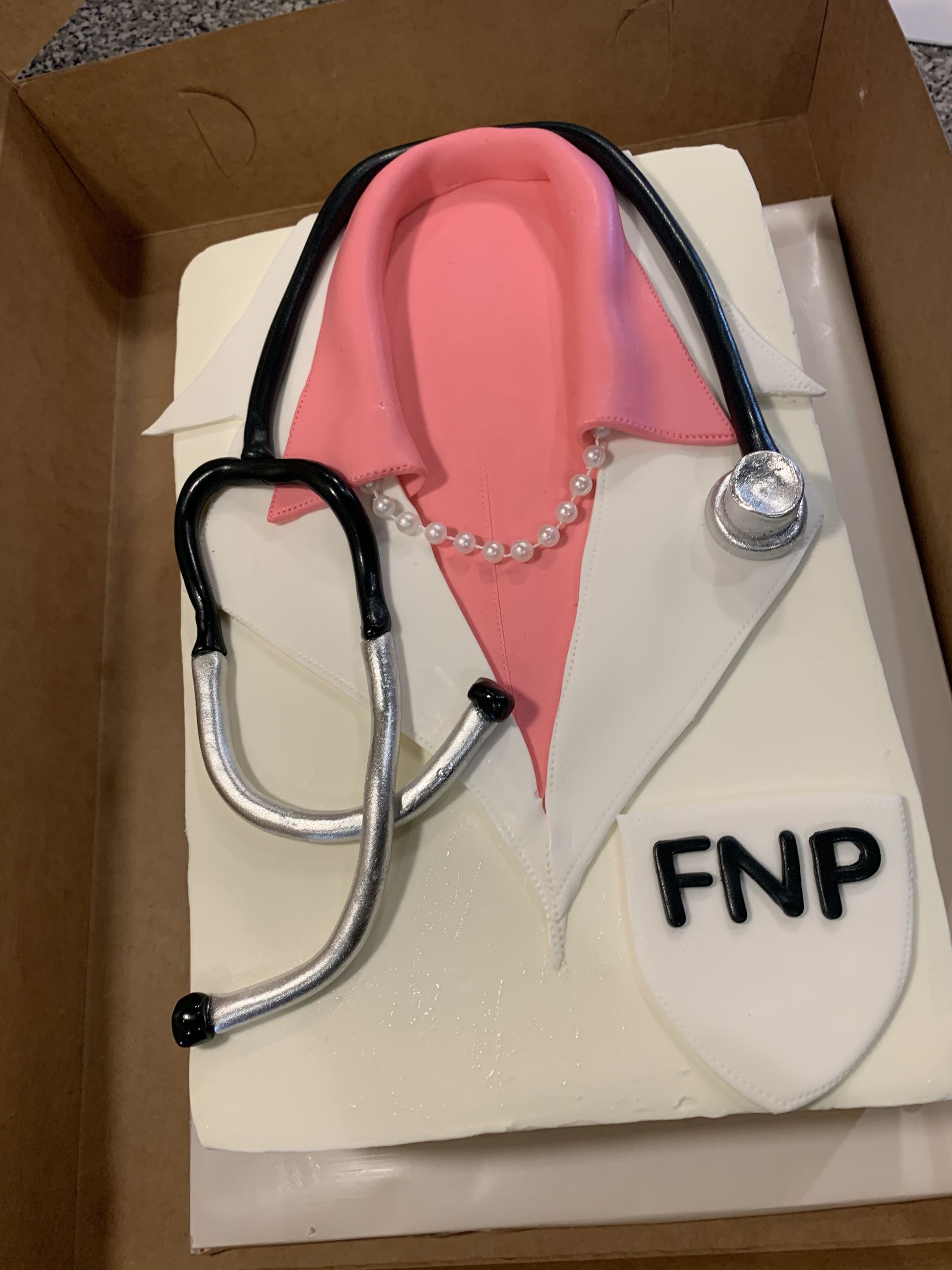 a cake with a stethoscope and the word fnp on it