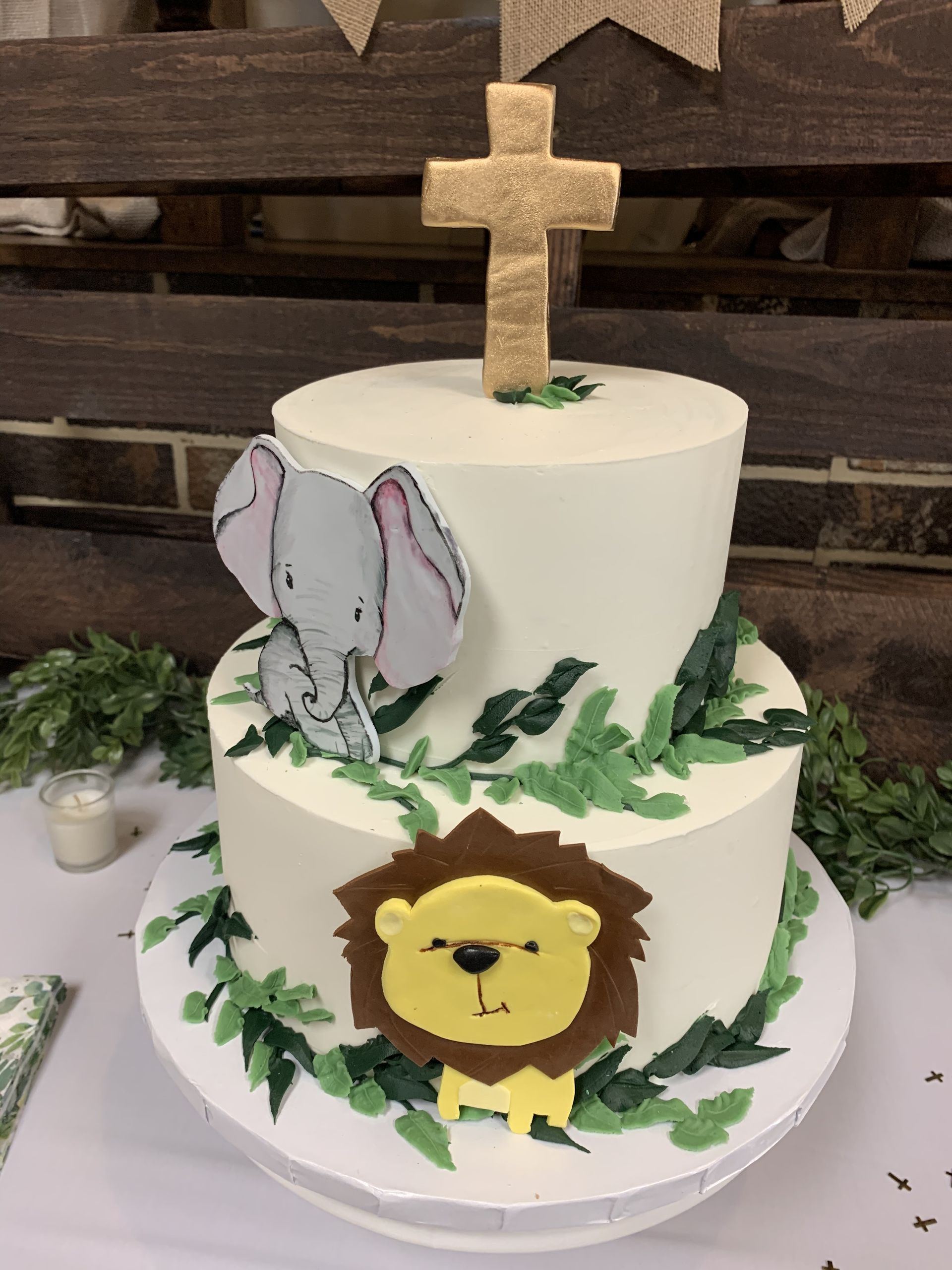 a cake with an elephant and a lion on it