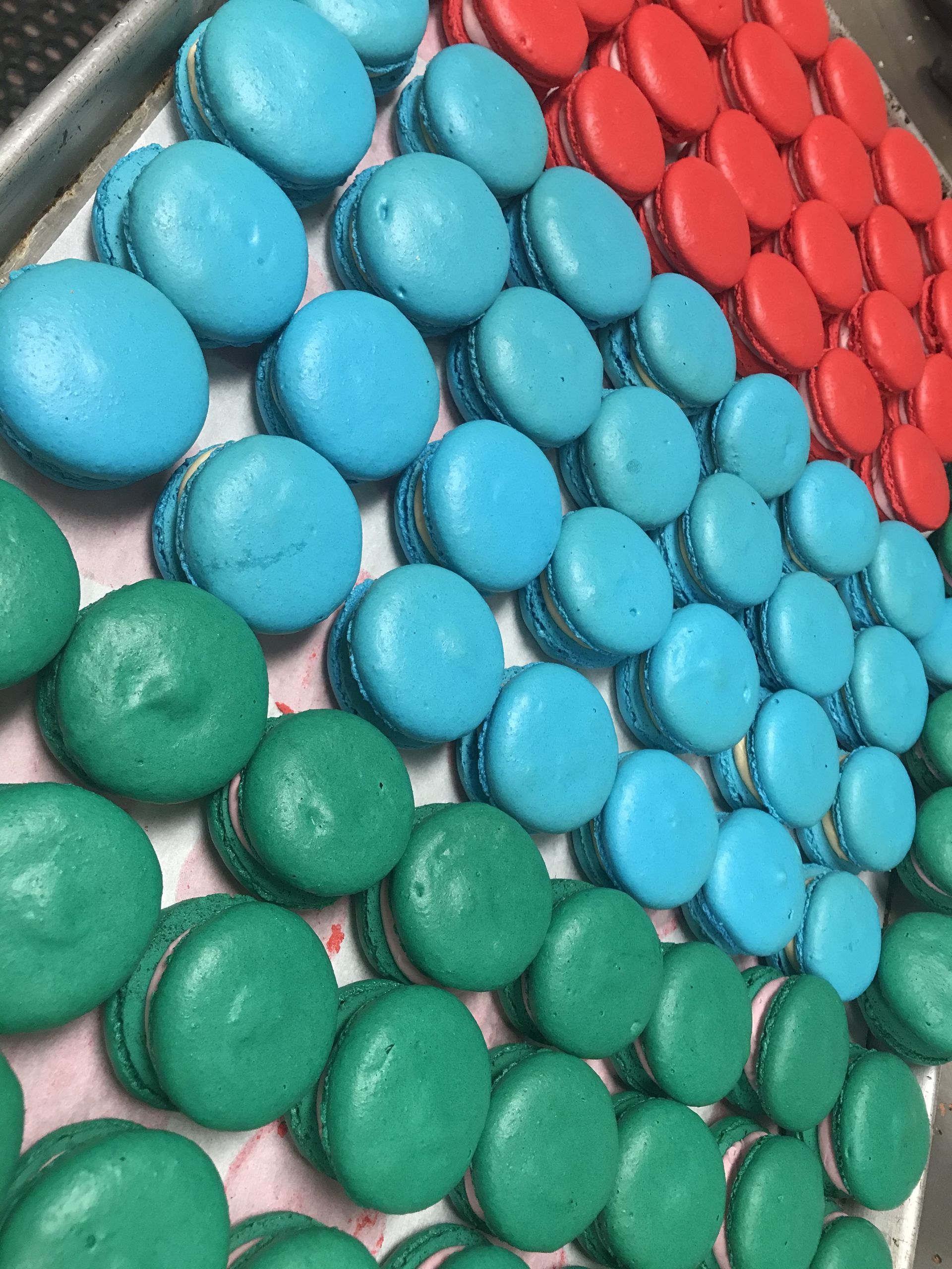 a bunch of different colored macarons on a table