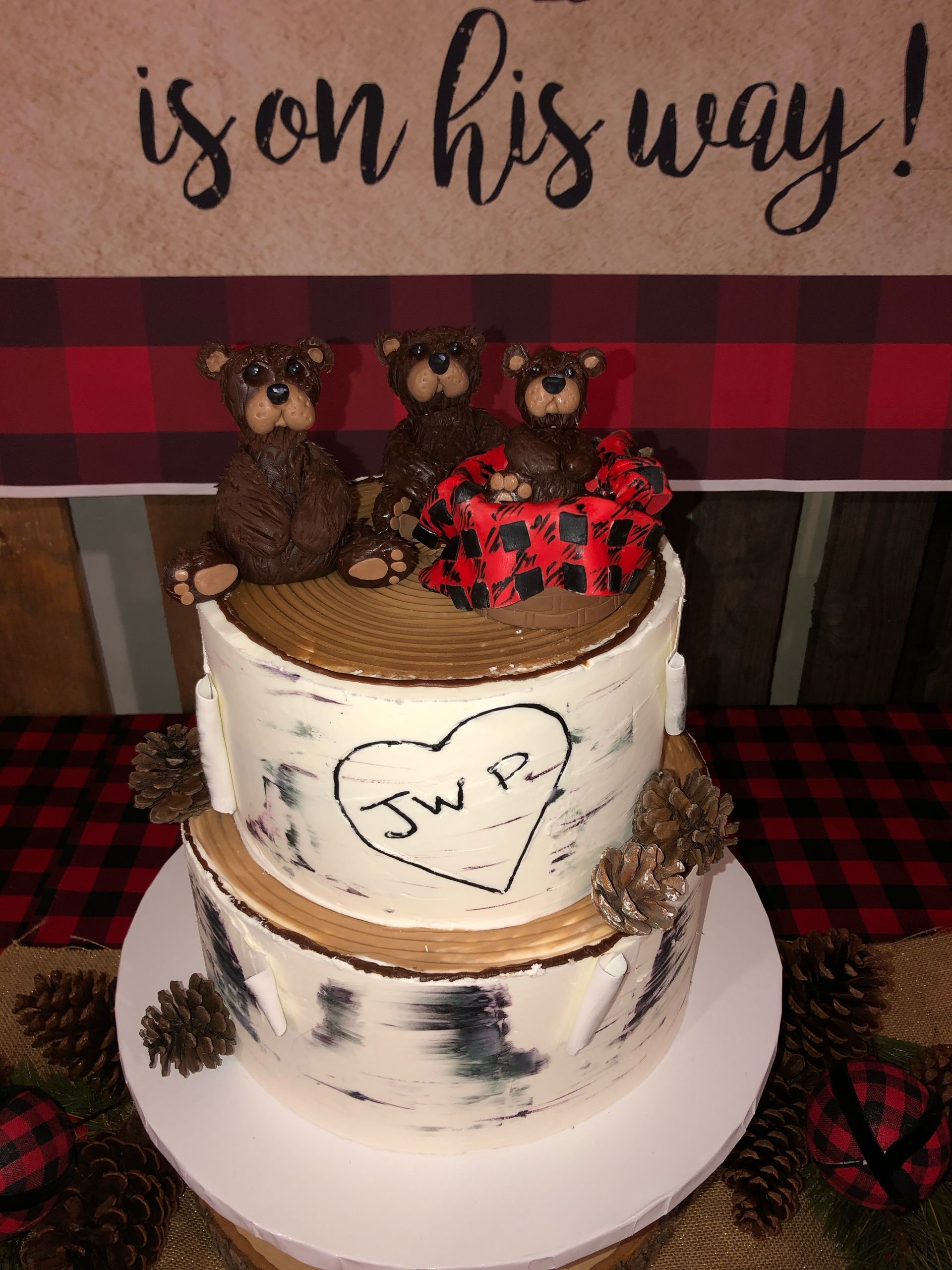 a cake with three teddy bears and a heart on it