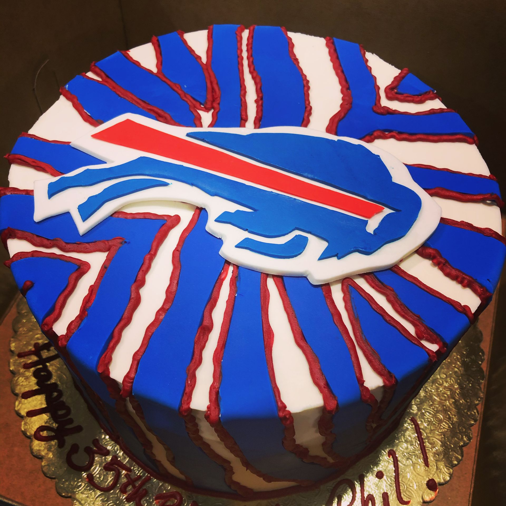 a birthday cake with a buffalo bills logo on it