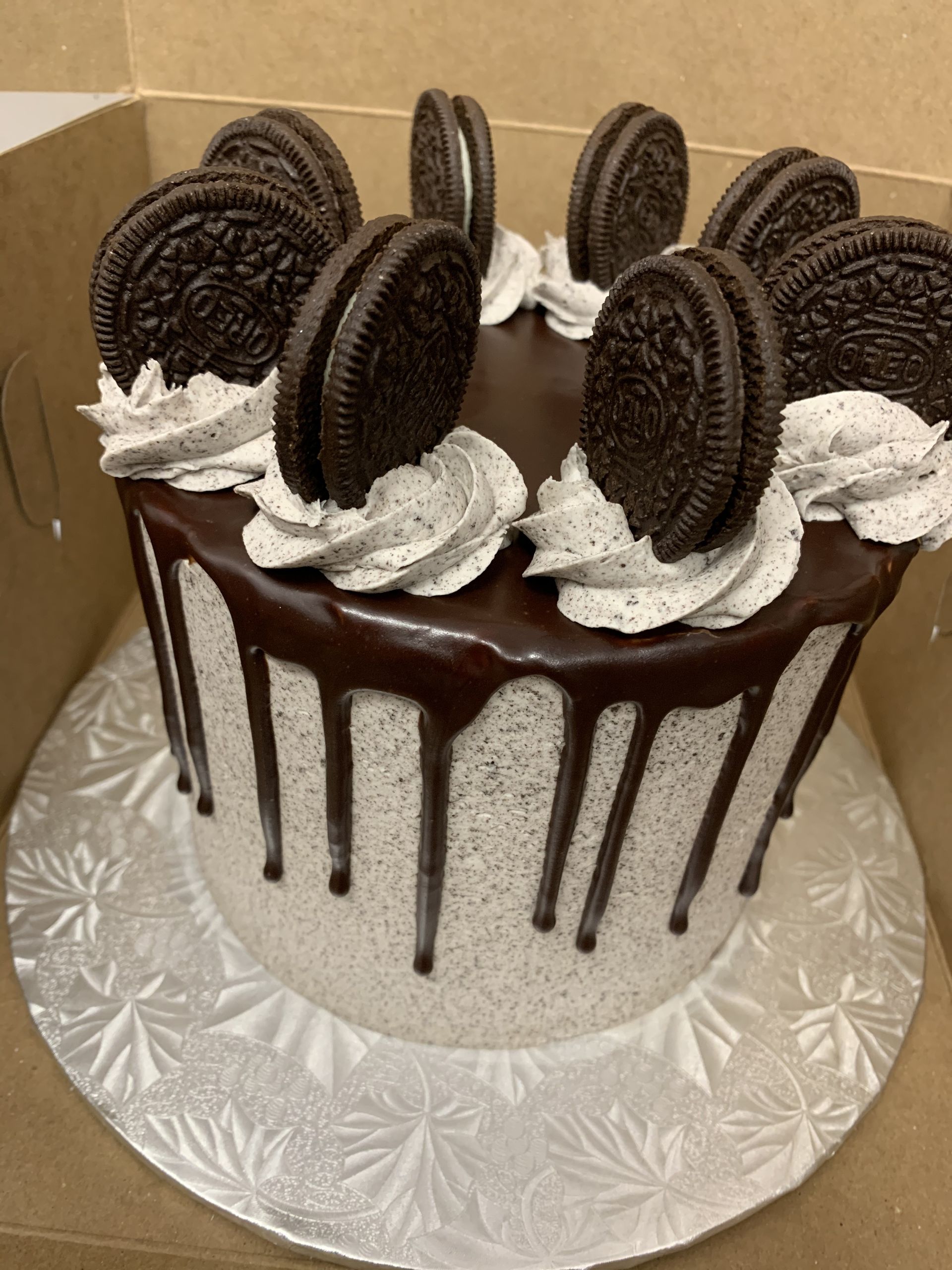 a cake with chocolate frosting and oreos on top
