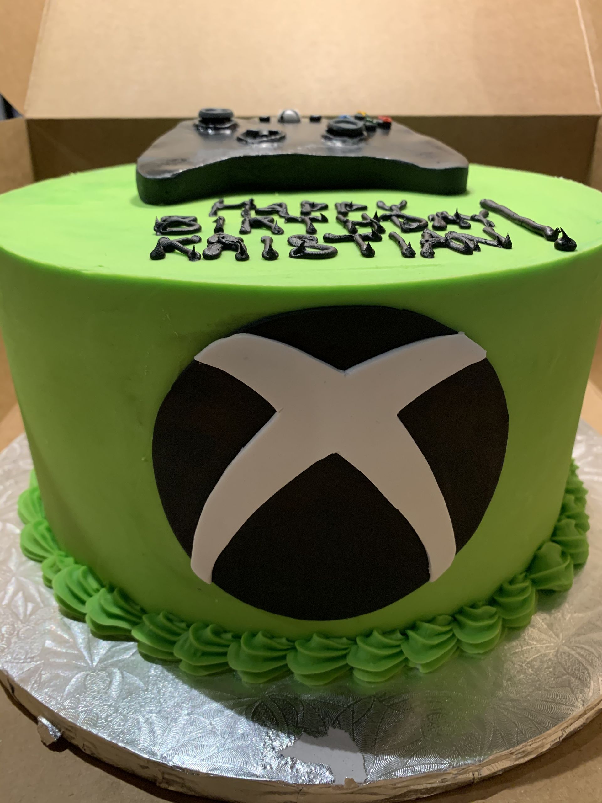 a green cake with an xbox logo on it