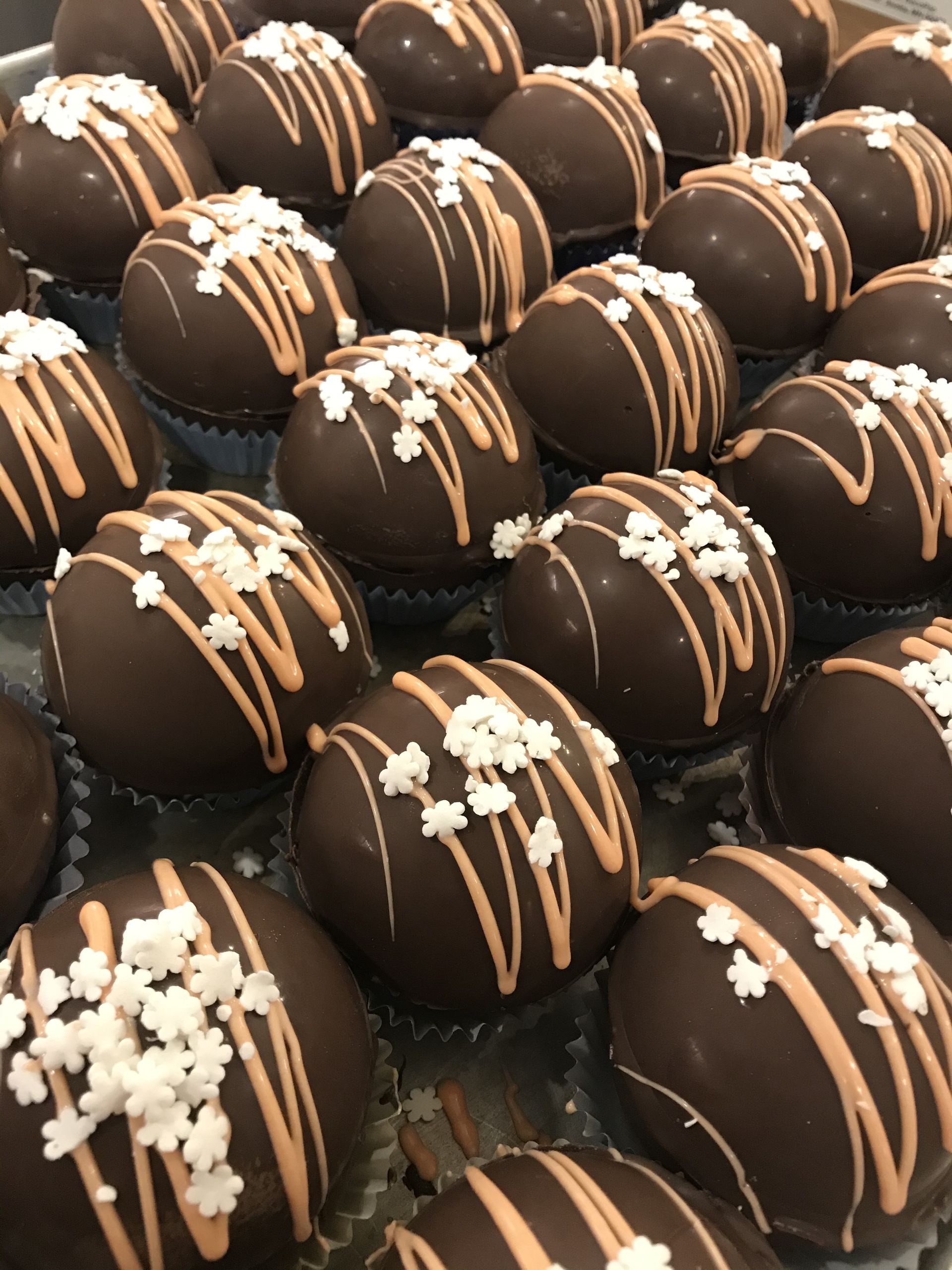 a bunch of chocolate covered cupcakes with sprinkles on them