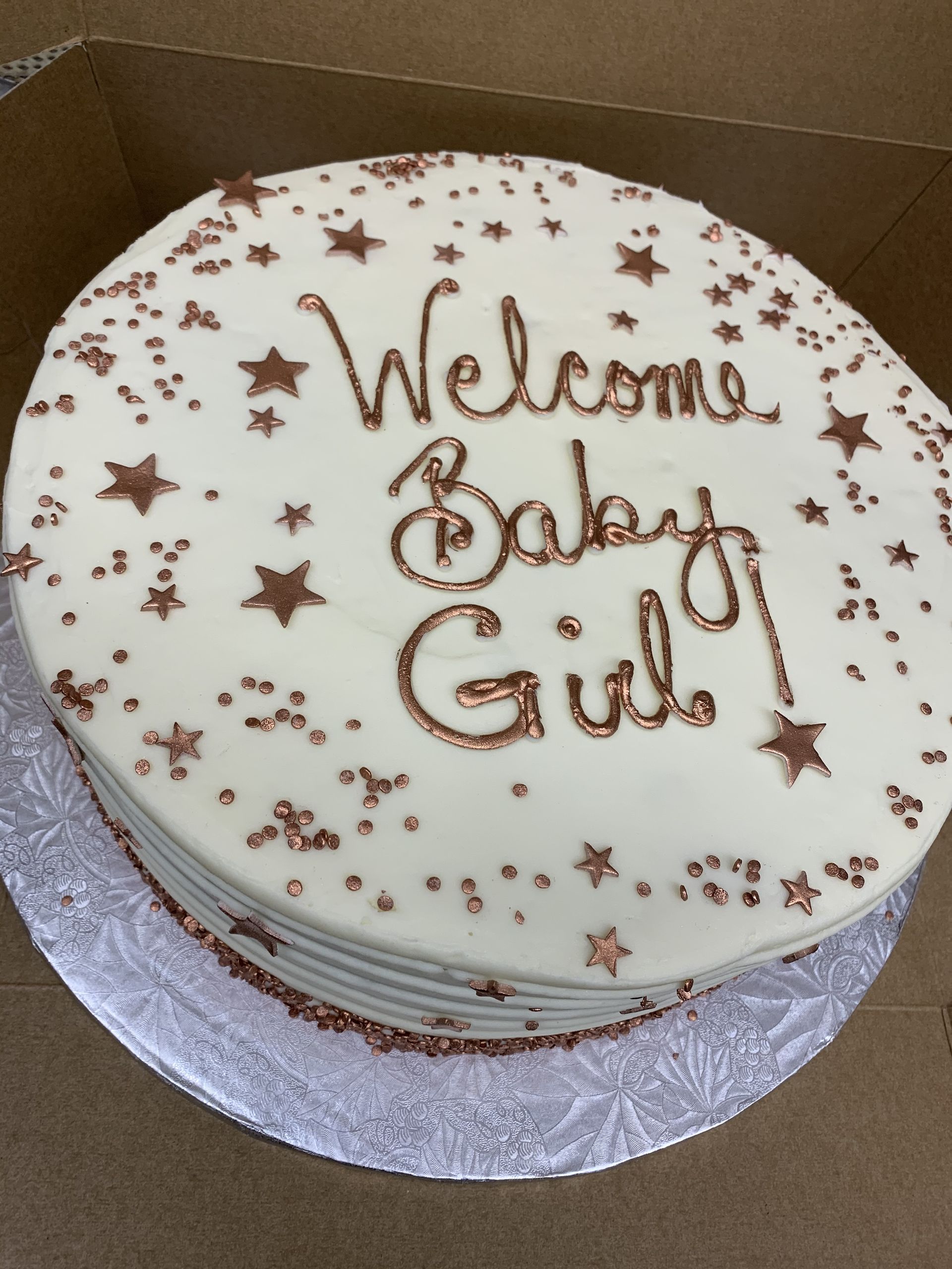 a cake that says welcome baby girl on it