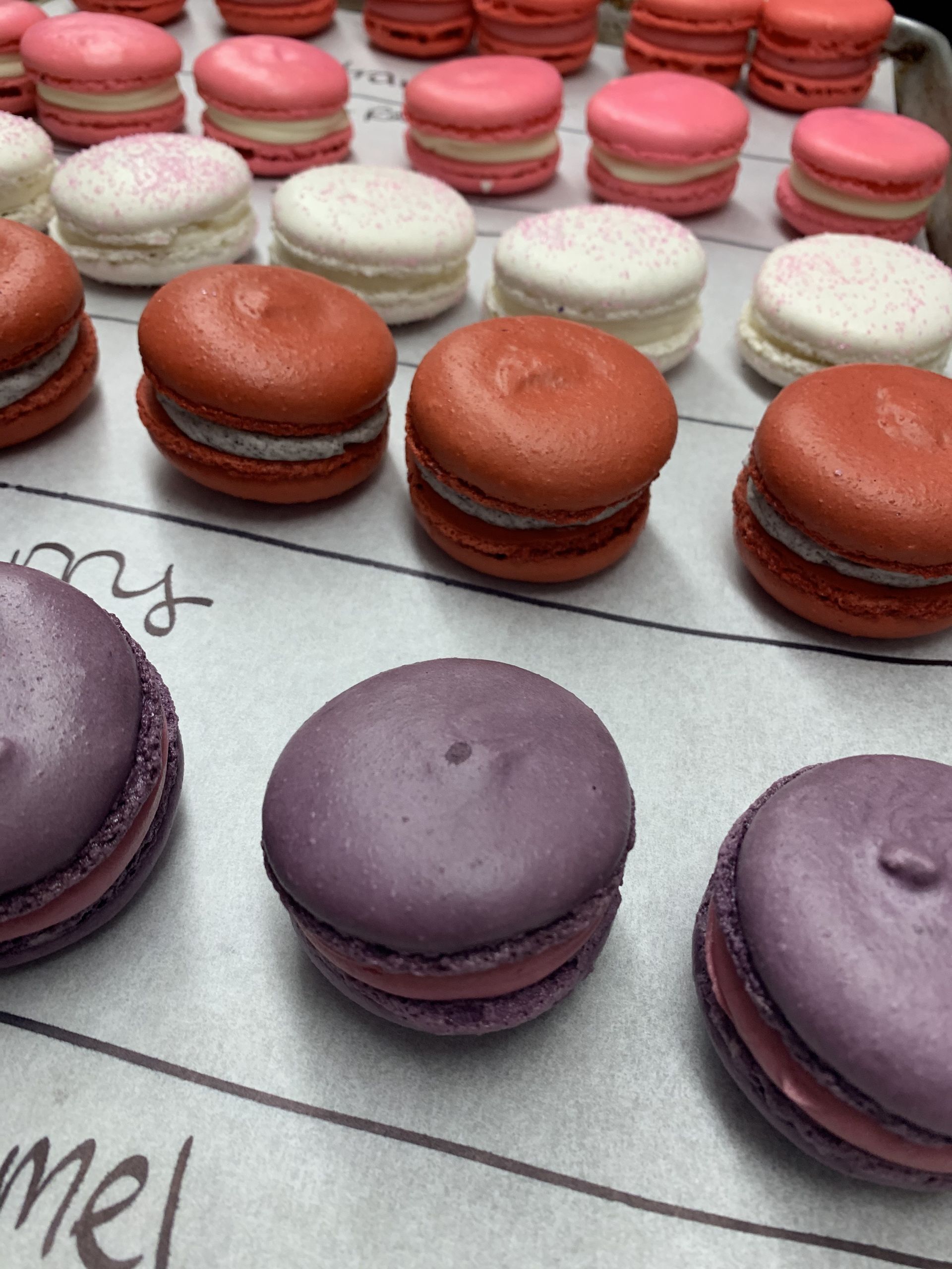 a bunch of different colored macarons are on a table